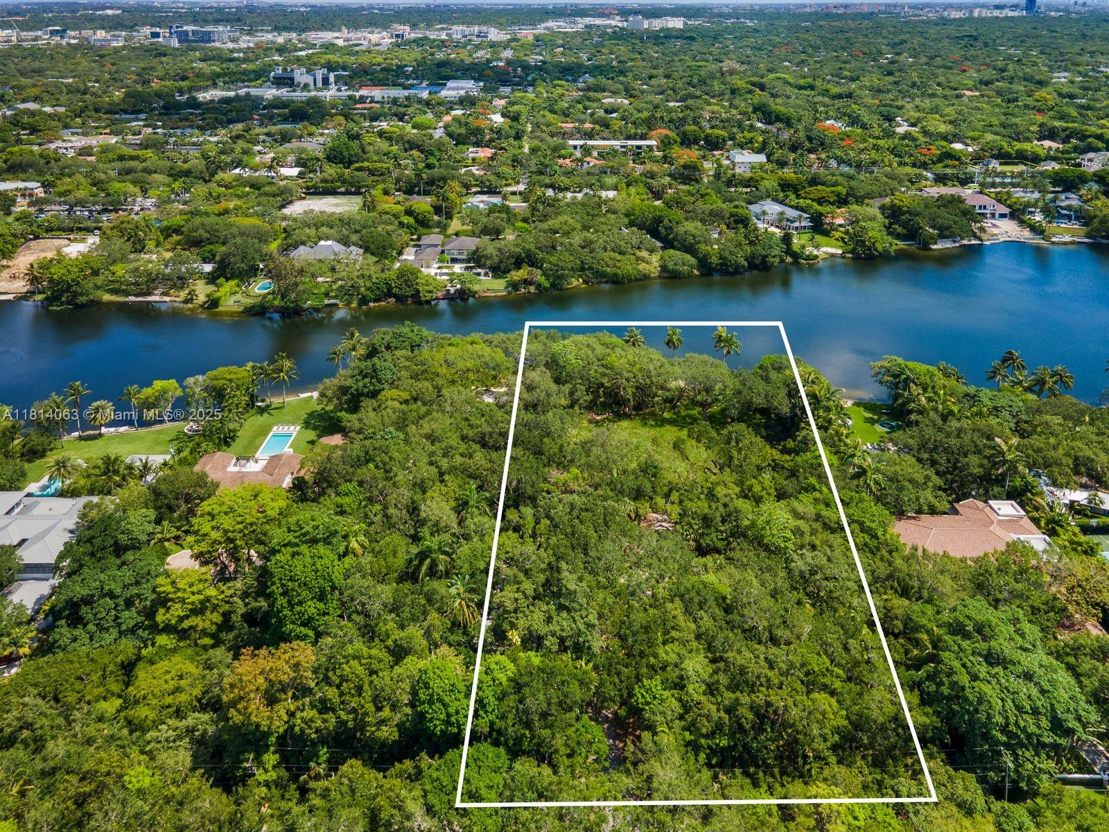 An extraordinary opportunity to build your dream home on a magnificent 2-acre lakefront lot in the prestigious gated community of Hammock Lakes. This rare offering features lush, mature landscaping with live oaks, sabal palms, palmettos and ferns, creating a serene, natural backdrop for your custom vision. With an existing dock providing direct access to the tranquil lake, the property invites a lifestyle that is both luxurious and closely connected to nature. Envision your own private oasis, where indoor elegance meets outdoor beauty—an estate ready to be tailored to your every desire.