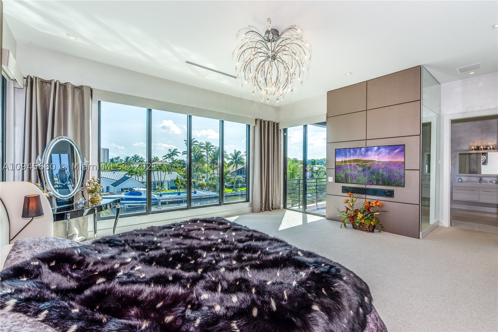 Extraordinary 2016  waterfront home features 10ft+ceilings, spacious floorplan incl.6 bedrooms and office. 5 bedrooms offer wood and leather finished walk-in closets and ensuite bathroom. Grand master suite with balcony has two oversized closets and impressive wall decor. Venetian plaster finish, wood and fabric wall panels are present all through the home. 5,671 sq. ft. contemporary delight is great for entertaining. Open gourmet kitchen, chefs gas range, Sub-zero fridge with built in wine cooler. Outside features the fire deck table and BBQ/sink/fridge stand. Oversized sliding windows and doors are complemented by water view, salt water pool, hot tub, boat lift