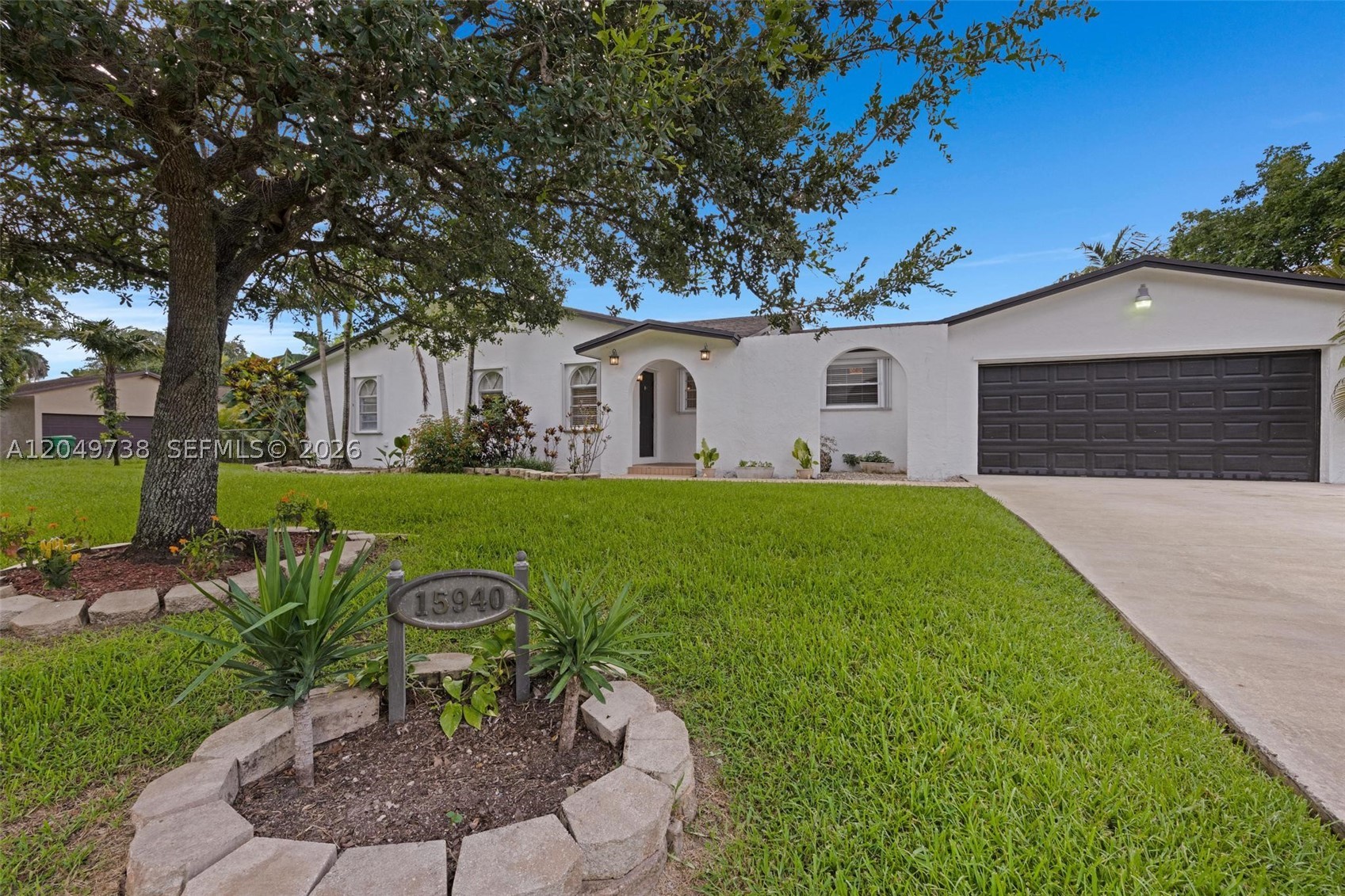 NO HOA! OVERSIZED 15,000 SQ. FT. CORNER LOT! BRING ALL THE TOYS! Rare opportunity to own this spacious 4BR/2BA home in desirable Waldin Park Estates with exceptional parking, including a front driveway accommodating 4–5 vehicles plus an extra-long rear driveway with easy backyard access for RVs, boats, trailers, work vehicles, and even semi trucks! The backyard also features a 12' x 24' concrete slab with endless possibilities for a future shed, workshop, or tiny home (where permitted). Escape to your own private tropical oasis featuring a fully fenced backyard, lush mature landscaping, a 10-ft privacy hedge, and fruit-producing mango, avocado, and banana trees. Relax on the large screened Chicago-brick patio with two French doors. Inside you'll find tile flooring throughout, granite kitchen countertops and bath vanities, fresh interior paint, professionally painted exterior (2023), a separate laundry room, and a bright, functional layout. Major updates include a 2019 50-year dimensional shingle roof, automatic sprinkler system with new pump, heads, and plumbing, water softener (under 2 years old), freshly serviced A/C, newer appliances, and accordion hurricane shutters throughout. Conveniently located near parks, shopping, top-rated schools, U.S. 1, Krome Ave., and the Florida Turnpike, with easy access to Miami and the Florida Keys. If you've been looking for space, privacy, exceptional parking, and NO HOA, this is the one!