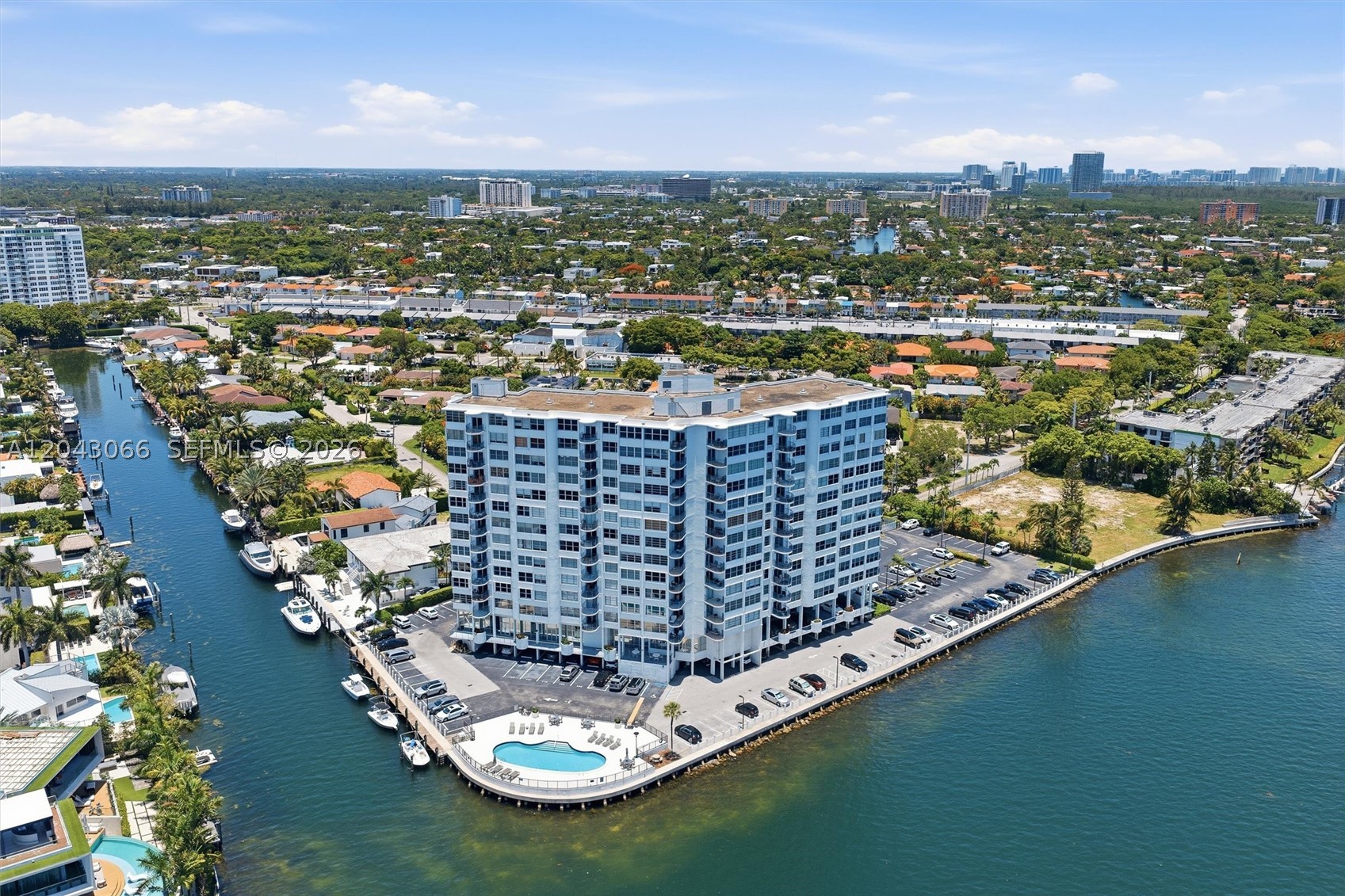 Tranquil canal and waterway views from this spacious 2BR/2BA, 1,181 SF residence at Majorca Towers — a waterfront building tucked into North Miami's coveted, tree-lined Sans Souci Estates. Northwest exposure overlooks the canal below and bathes the home in afternoon and sunset light, with a bright layout flowing to a private balcony. Generous closets and abundant natural light throughout. Includes a prime covered parking space — the first spot, just steps from the lobby entrance. Resort-style amenities: bayfront pool, fitness center, community boat dock with slips available, billiard room, on-site management, and gated, secured parking. Minutes to Bal Harbour Shops, Surfside beaches, and Biscayne Blvd dining; quick access to US-1 and both airports. A rare waterfront value in a serene Biscayne Bay enclave.