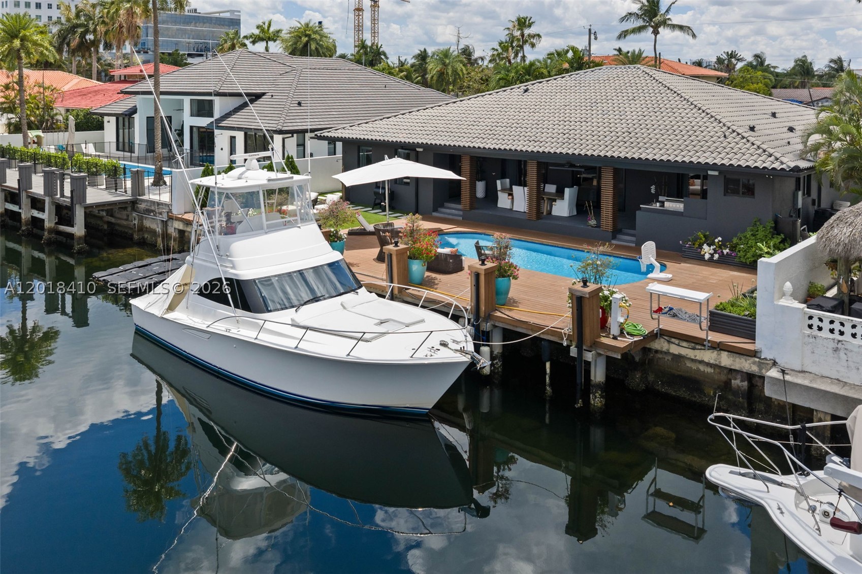 Step into this meticulously renovated residence in the Western Gate of Eastern Shores, an enclave of single-family waterfront homes.
This 5-bedroom EACH W/ EN-SUITE BATH, plus cabana is
Introduced by a DRAMATIC PIVOT ENTRY DOOR with switchable privacy glass,
The chef kitchen is outfitted with premium MIELE appliances, induction cooktop, and fully integrated cabinetry-clad appliances. The island features waterfall leathered countertop finish and double-sided cabinetry.
Smart, sophisticated, and detail driven, the home includes customized closets with integrated motion sensored lighting, motorized window treatments, Sonos Sound System, and a SPA INSPIRED primary suite with Dual closets and bathrooms, featuring separate STEAM SHOWER, JACUZZI TUB + 2 smart toilets. A flexible multi-space 2 car garage with a/c split.
Enjoy expansive waterfront living designed for entertaining and relaxation with Summer Kitchen, Shore Power, no fixed bridges, fast ocean access, and 85’ of waterfront.  Ideally positioned moments from Uptown Harbour, a transformative waterfront destination set to elevate the area with green space, marina, dining and retail, and more.
