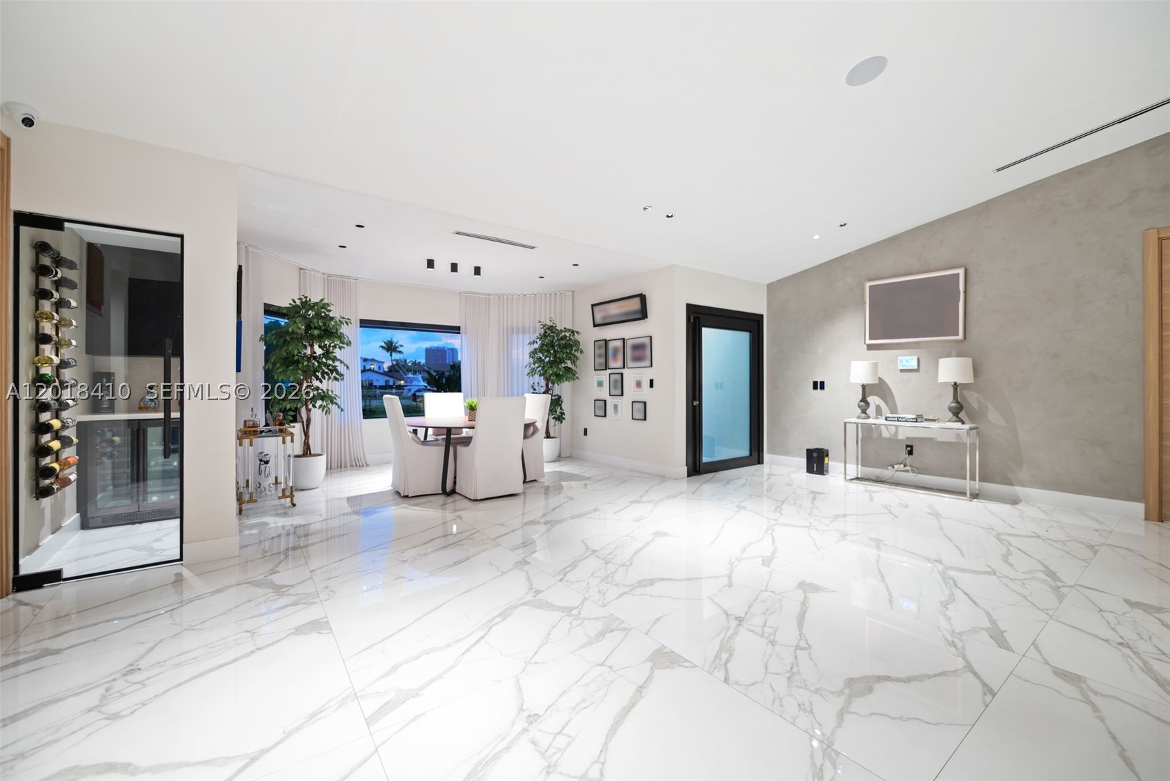 Step into this meticulously renovated residence in the Western Gate of Eastern Shores, an enclave of single-family waterfront homes.
This 5-bedroom EACH W/ EN-SUITE BATH, plus cabana is
Introduced by a DRAMATIC PIVOT ENTRY DOOR with switchable privacy glass,
The chef kitchen is outfitted with premium MIELE appliances, induction cooktop, and fully integrated cabinetry-clad appliances. The island features waterfall leathered countertop finish and double-sided cabinetry.
Smart, sophisticated, and detail driven, the home includes customized closets with integrated motion sensored lighting, motorized window treatments, Sonos Sound System, and a SPA INSPIRED primary suite with Dual closets and bathrooms, featuring separate STEAM SHOWER, JACUZZI TUB + 2 smart toilets. A flexible multi-space 2 car garage with a/c split.
Enjoy expansive waterfront living designed for entertaining and relaxation with Summer Kitchen, Shore Power, no fixed bridges, fast ocean access, and 85’ of waterfront.  Ideally positioned moments from Uptown Harbour, a transformative waterfront destination set to elevate the area with green space, marina, dining and retail, and more.