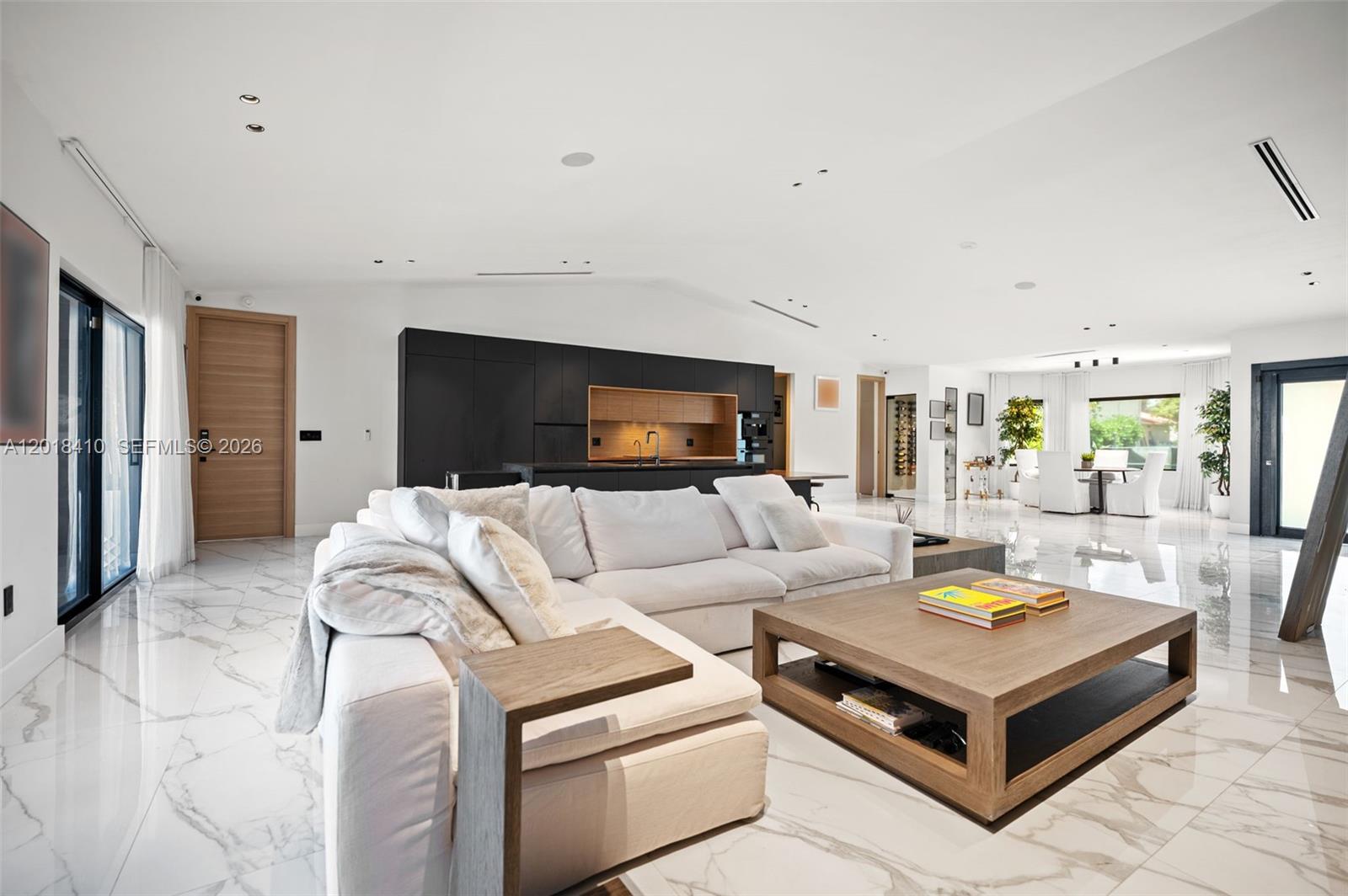 Step into this meticulously renovated residence in the Western Gate of Eastern Shores, an enclave of single-family waterfront homes.
This 5-bedroom EACH W/ EN-SUITE BATH, plus cabana is
Introduced by a DRAMATIC PIVOT ENTRY DOOR with switchable privacy glass,
The chef kitchen is outfitted with premium MIELE appliances, induction cooktop, and fully integrated cabinetry-clad appliances. The island features waterfall leathered countertop finish and double-sided cabinetry.
Smart, sophisticated, and detail driven, the home includes customized closets with integrated motion sensored lighting, motorized window treatments, Sonos Sound System, and a SPA INSPIRED primary suite with Dual closets and bathrooms, featuring separate STEAM SHOWER, JACUZZI TUB + 2 smart toilets. A flexible multi-space 2 car garage with a/c split.
Enjoy expansive waterfront living designed for entertaining and relaxation with Summer Kitchen, Shore Power, no fixed bridges, fast ocean access, and 85’ of waterfront.  Ideally positioned moments from Uptown Harbour, a transformative waterfront destination set to elevate the area with green space, marina, dining and retail, and more.