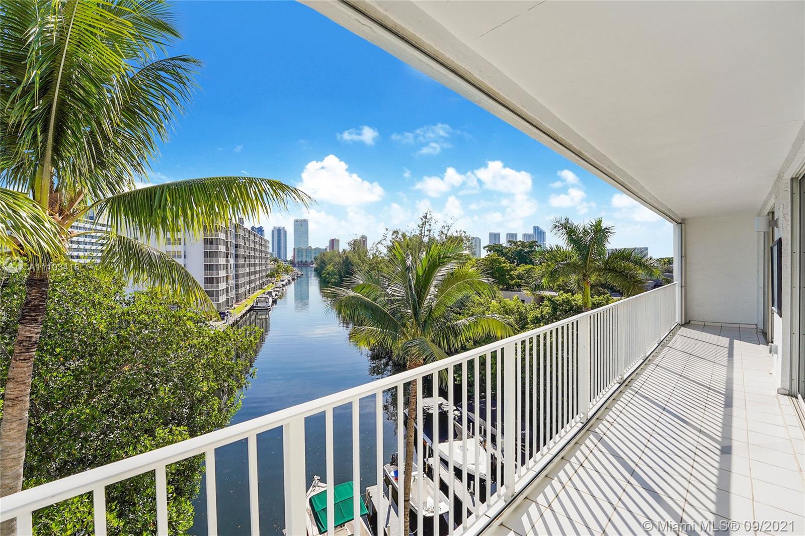 Boutique 4 story 12-unit bld in Eastern Shores (N Miami Beach) This gated boating community features a 3 Bed 2 bath 1,270 square foot condo, boat dock slip(transfers with unit) (12W & 15L) with water/electric (110V), deep wide canal/no fixed bridges.  Top floor, 2 parking spaces, storage unit, East canal/dock views – Great natural light. 40 Ft balcony facing E with long-range canal views into Sunny Isles Bay & skyline. Master has canal views, 2 guest rooms face West, Living/Dining Rm combo, Wet bar, E/W  windows, Tiled Flrs, Lndry, Recessed lights, SS appliances, Granite kitchen, Wood cabinets, & Hurricane shutters.  BLD features private pool with shower, 2nd floor tanning deck, Rec room & small gym - GR8 waterfront location for boaters Hop-skip-and-jump to the beach, Shopping, Restaurants
