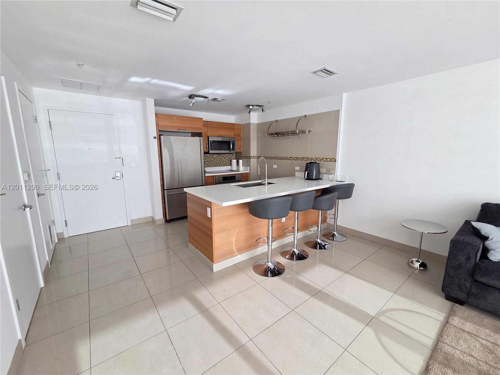 1 large B and 1.5 bath  , open kitchen with SS appliances and an open concept dining island, walk-in closet and private balcony, W&D inside unit, ready to move in. Located steps from Wynwood and the Design District, this pet-friendly building offers resort-style amenities including a pool with cabanas, BBQ area, gym, sauna and steam room, yoga room, clubhouse, business conference area, private parking. Walking distance to over 50 restaurants, shops and services, this is your chance to be the primary owner or investor of a prime property in a growing area with strong rental demand!