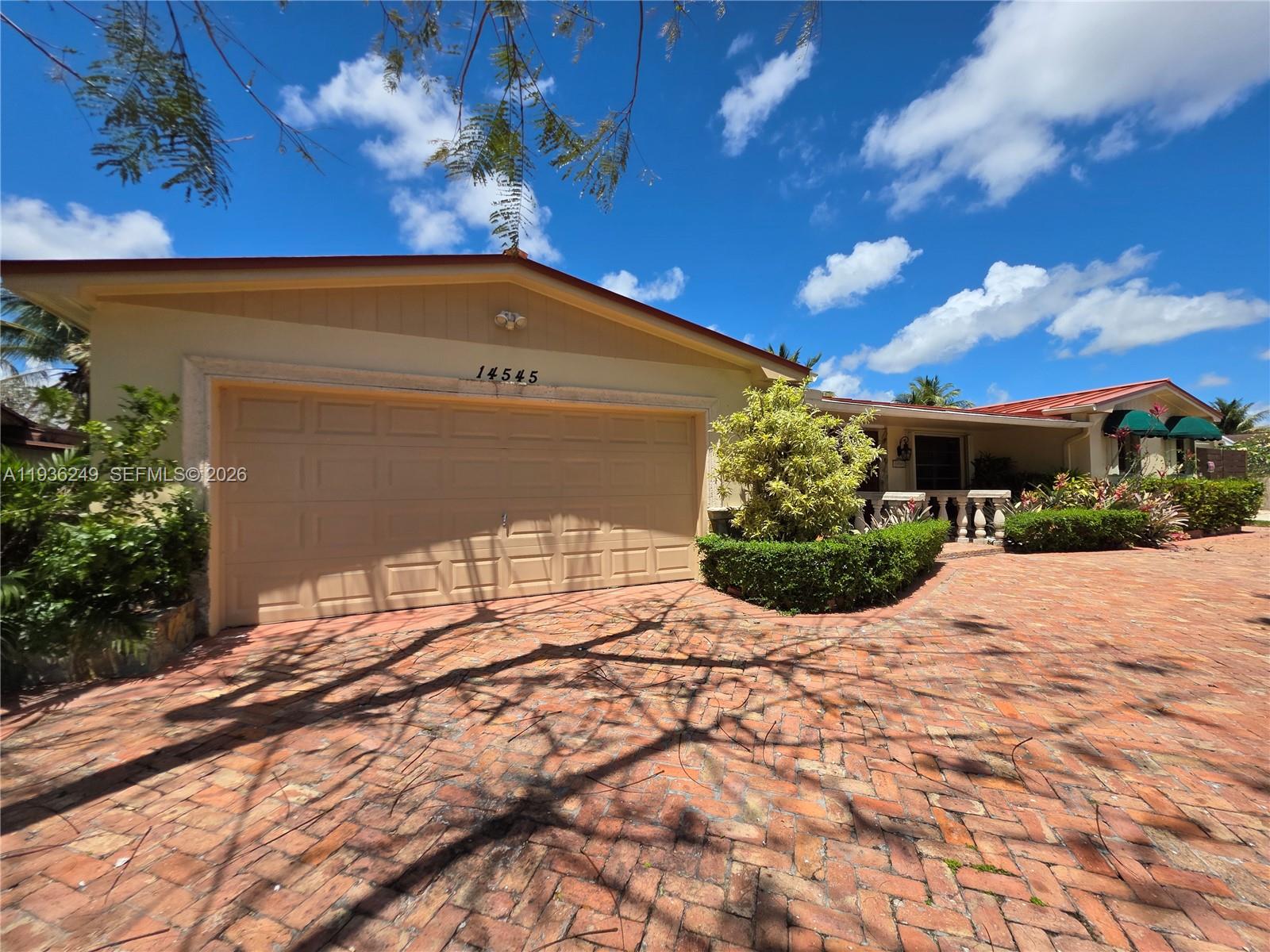 Welcome to this beautifully maintained 1974 waterfront home located in the highly desirable and quiet community of Kendale Lakes. This spacious residence offers breathtaking lakefront views and a seamless indoor–outdoor lifestyle, perfect for both relaxing and entertaining. The home features a large, open kitchen and an expansive family room filled with natural light and stunning views of the water. Sliding doors throughout the living areas open completely to the oversized deck, allowing you to effortlessly blend indoor and outdoor living—ideal for gatherings, entertaining, or enjoying peaceful sunsets by the lake.   Surrounded by lush landscaping, the property offers privacy and a serene atmosphere rarely found. A circular driveway provides ample parking and adds to the home’s impressive curb appeal. With generous living spaces, tranquil lake views, and a prime location in a quiet neighborhood, this home is a rare opportunity to enjoy Florida living at its finest. ALARM AND SURVEILLANCE CAMARAS AT PREMISES