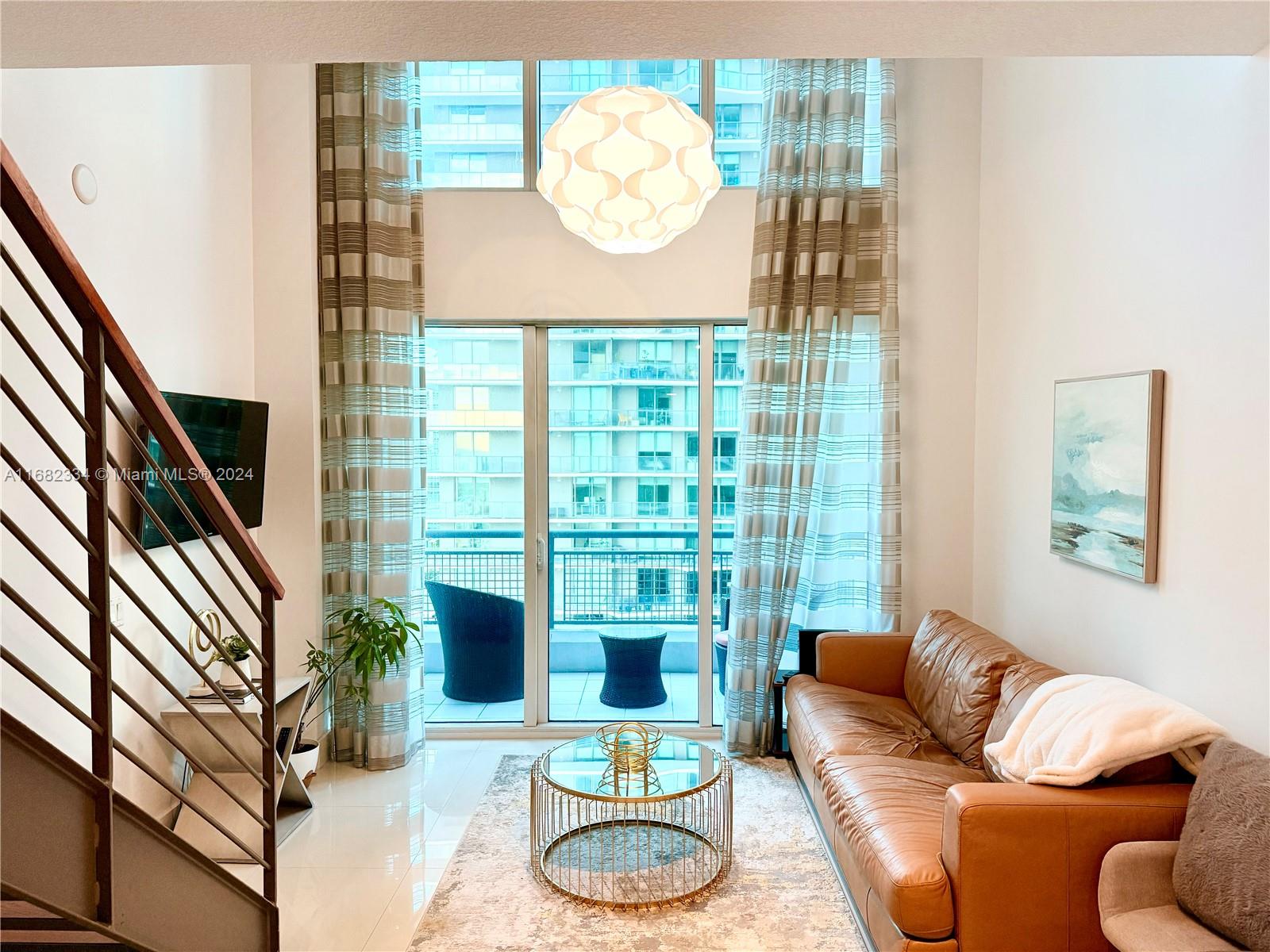 Stunning furnished 1-bedroom, 1.5-bath loft on the 26th floor of Infinity at Brickell. Features white porcelain tile flooring, upgraded bathroom vanities, stainless steel appliances, black kitchen backsplash, custom pantry with sliding door, and a built-in table with matching black granite. Enjoy privacy with custom curtains and double-height drapery, plus two wall-mounted TVs. The spacious bedroom includes an extended walk-in closet. Washer/dryer in unit, basic HD cable, internet, and one parking space included. Walk in distance to Brickell City Centre, Mary Brickell Village, and great restaurants and bars.