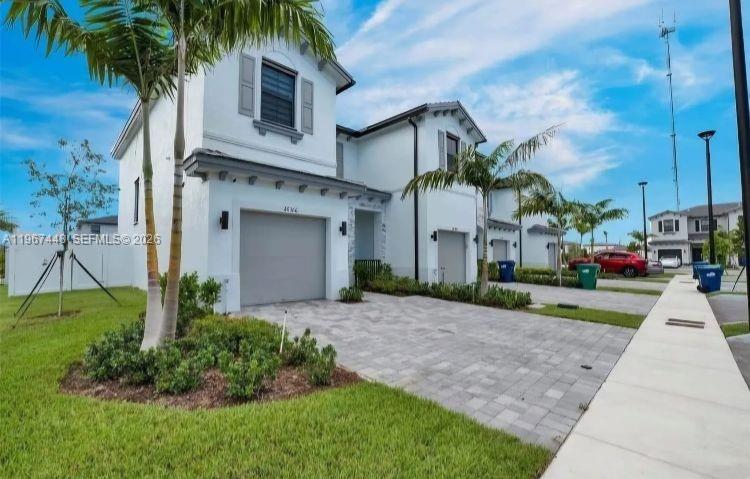 Welcome Home to this Luxurious New Construction Townhouse located in the most thriving city of Miami Gardens! This Amazing 1600 SqFT home boasts 3 spacious bedrooms, 2.5 bathrooms, 1 car garage and space for 2 additional cars on it’s brick paved driveway. While Packing premium Features that include an Open floor-plan kitchen with granite countertops, soft close shaker cabinets, Tile flooring, zebra window blinds, built in Smart Home System, and stainless steel appliances still covered under warranty. This corner lot model has the perfect backyard for entertaining family and friends while covered with a privacy fence all around. This gated community offers vacation style amenities as in a fitness center, pool and clubhouse