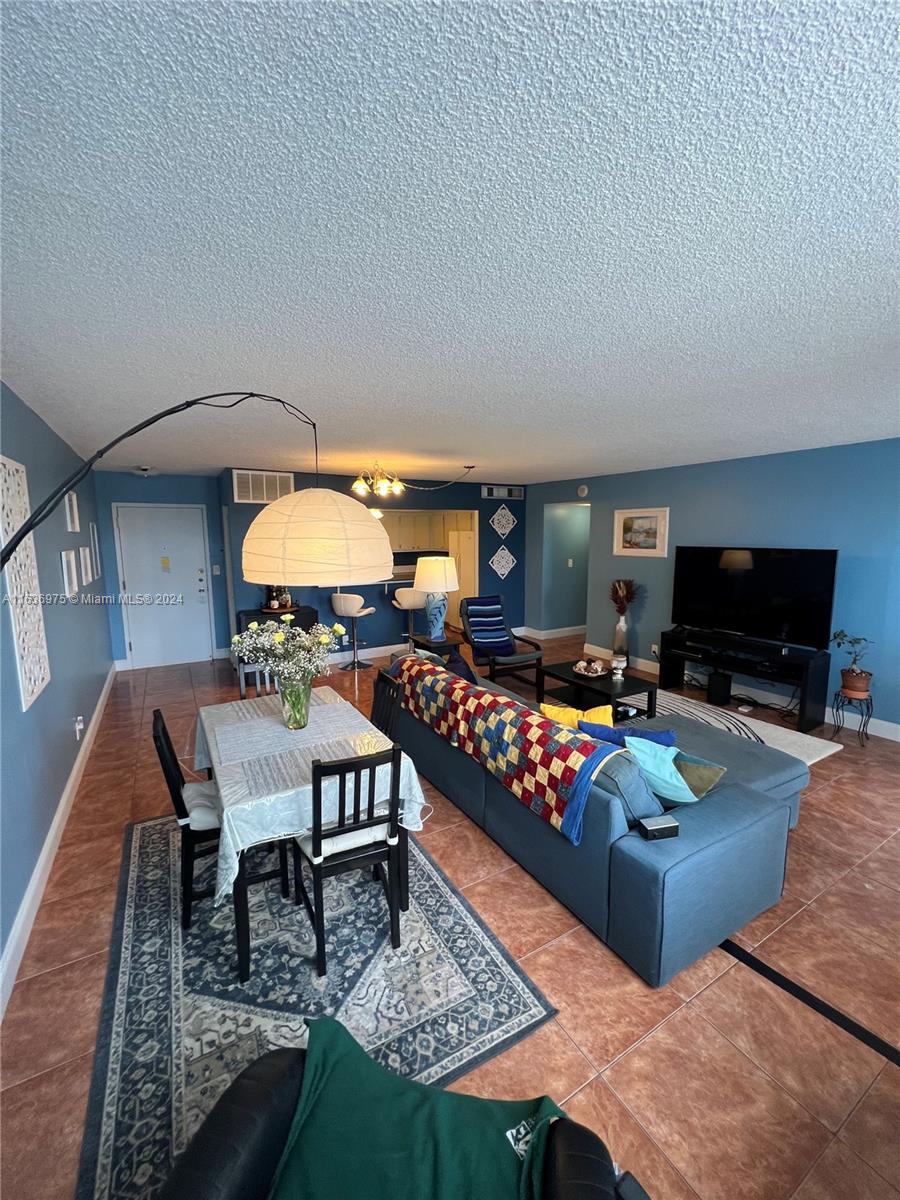 PRIME LOCATION IN THRIVING SAN SOUCI - IN THE HEART OF NORTH MIAMI! Spacious 2/2 corner unit in iconic Bayview Towers. Surrounded by water & steps to Biscayne Bay. Bright & inviting condo offers the perfect blend of comfort & convenience. Oversized bdrms, balcony, tiled throughout, open floor plan connects living/dining/kitchen. Huge Primary includes ensuite bathroom, 2 walls of windows flood the space with natural light. Expansive walk-in closet/functional office. Secure-access building & lobby entrance. One assigned gated parking space, Cable & WIFi are included. Massive pool has recently been renovated, fitness room, community room, well-maintained same-floor laundry. Kitchen ready for your customization. Seller priced condo accordingly.