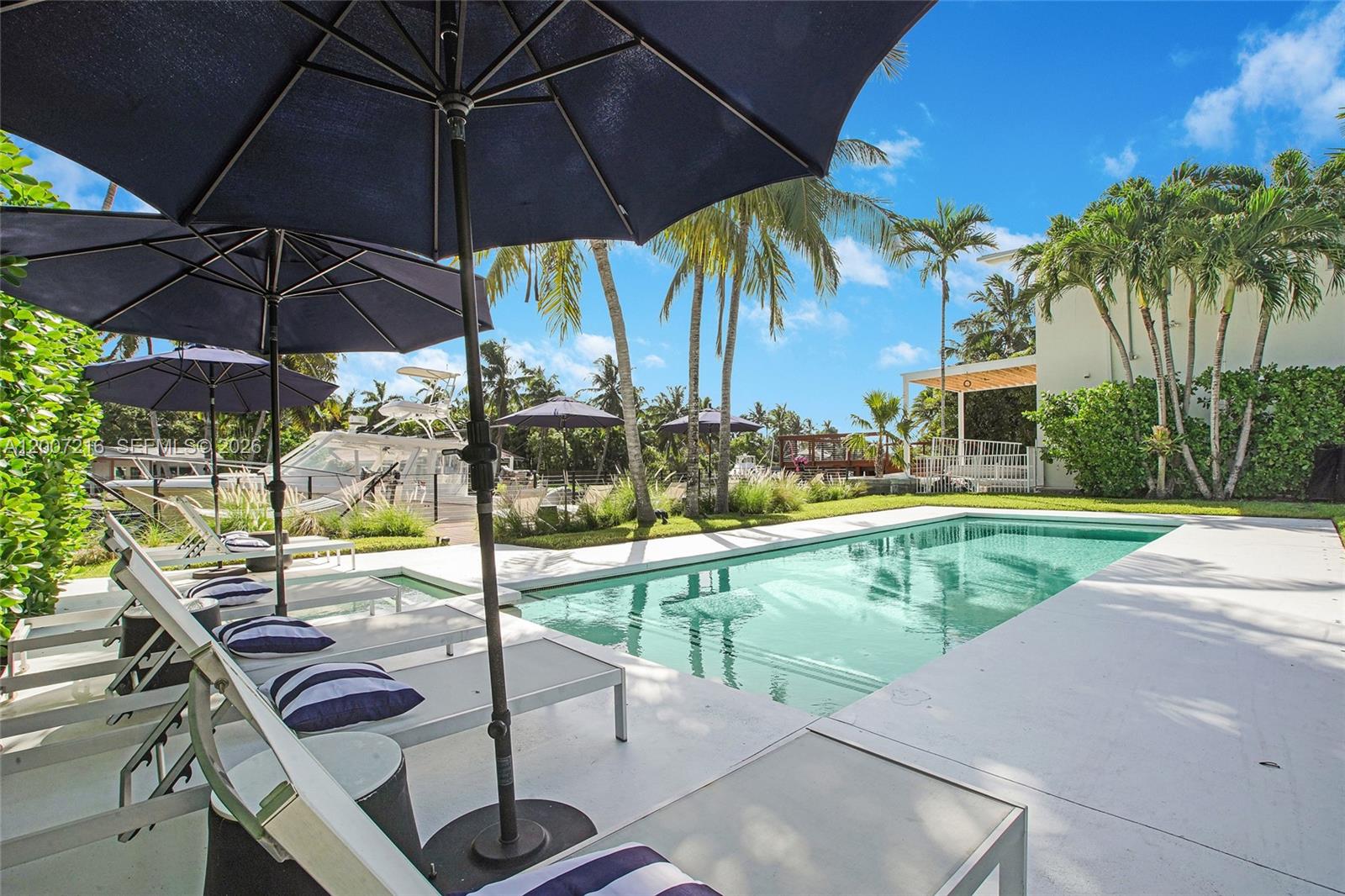 Fully renovated waterfront residence in the gated community of Belle Meade, set on one of the highest elevation lots in the neighborhood. Positioned above current flood requirements and eligible for a favorable flood certificate, offering a rare advantage for waterfront ownership in Miami.

Completed in 2020, this fully permitted renovation included all new electrical, plumbing, and structural upgrades. The home features a new roof, dual HVAC systems, tankless water heaters, buried FPL power lines, and hurricane impact windows and doors throughout.

The interior showcases a custom Italkraft kitchen with Sub-Zero and Wolf appliances including convection oven, steam oven, warming drawer, and wine storage. Natural stone finishes, a custom wood bar, and spa-style bathrooms with Hansgrohe fixtures elevate the design. Smart home features include Lutron lighting, Cat 5 wiring, and a multi-zone Sonos sound system inside and out.

Outdoor living is equally impressive with a saltwater pool, electric heater, outdoor kitchen, and professionally landscaped grounds. The new composite dock includes a 27,000 lb boat lift & 76 feet of water frontage, power, water, and lighting, ideal for boaters.

Turnkey, high-elevation waterfront living in one of Miami’s most sought-after gated enclaves.