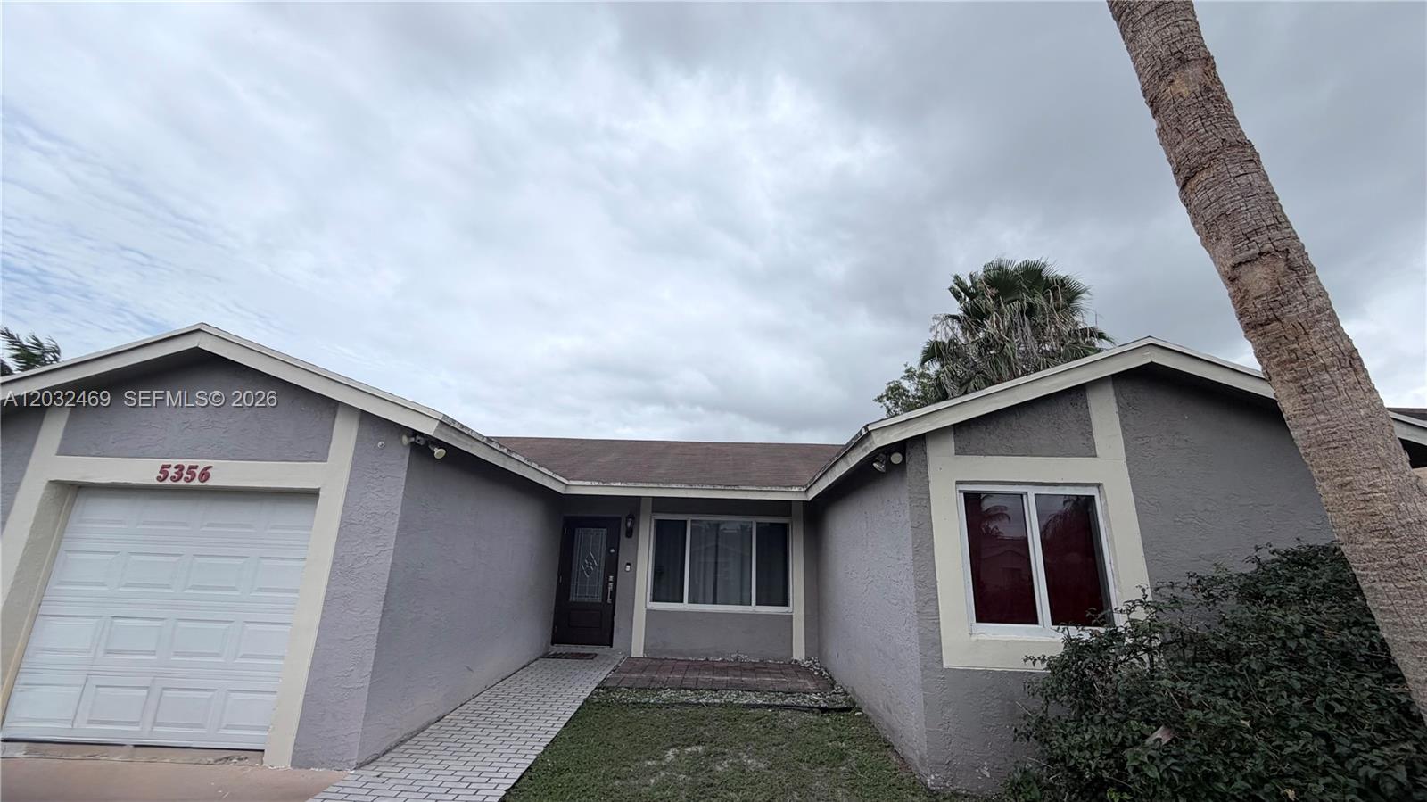 Spacious 3-bedroom 2-bath home on desirable corner lot with large backyard and patio in convenient Sunrise neighborhood. This charming house features new impact windows, providing enhanced storm protection and energy efficiency. Kitchen with stainless appliances, granite counters in kitchen and baths. Open and airy floor plan with vaulted ceilings, tile flooring throughout in main areas and laminate flooring in the bedrooms. One-car garage with washer and dryer included.