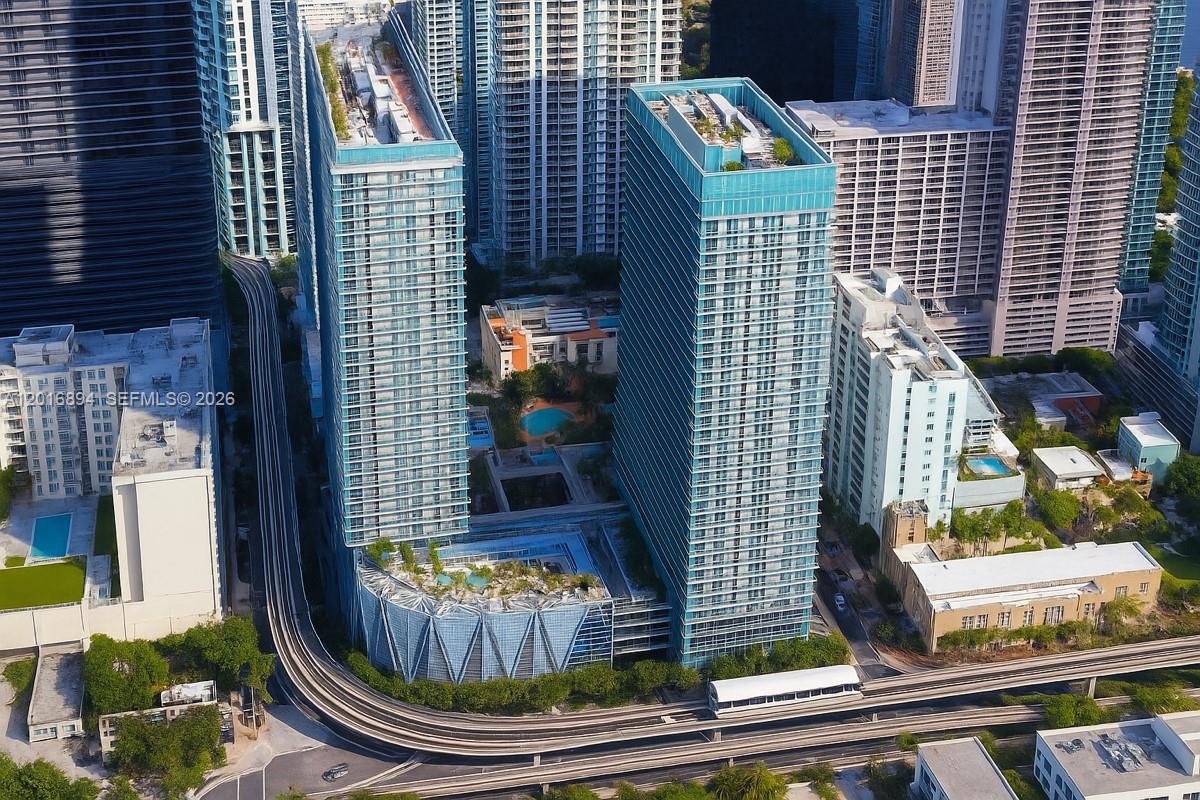 Welcome to Axis on Brickell South, a stunning 2 bed / 2 bath residence on the 28th floor featuring 1,106 sq ft of modern living space. This corner unit boasts wood-look porcelain floors, 9' ceilings, and impact floor-to-ceiling windows. Enjoy breathtaking southeast views of the Brickell skyline and Biscayne Bay from your expansive wraparound balcony. The gourmet kitchen features granite countertops and stainless-steel appliances. Includes full-size washer/dryer and assigned covered parking. Axis offers luxury amenities: two pools, spa, high-tech gym, theater, and 24/7 security. Unbeatable location steps from Brickell City Centre and Mary Brickell Village. Pet-friendly building. Experience the pinnacle of urban living.