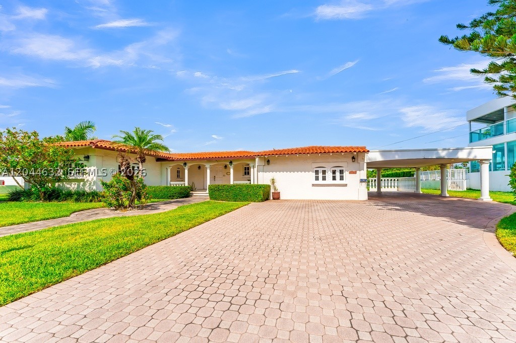 The only double waterfront lot currently available in North Bay Village, this extraordinary trophy property presents a once-in-a-generation opportunity to create a world-class waterfront estate. Spanning an impressive 17,966 SF with 128 feet of direct open bay frontage, this exceptional parcel captures unobstructed panoramic views of Biscayne Bay and the iconic Downtown Miami skyline. Positioned just one property from the point, the setting offers breathtaking sunrise and sunset vistas, sparkling city lights, and expansive open water views that are simply unmatched. Whether you're a developer, investor, or discerning end user, this is an unparalleled opportunity to build a signature luxury residence on one of the largest and most desirable waterfront lots in the area. The existing 3,317 SF residence with 3 bedrooms, 2 bathrooms + 2 powder rooms provides the option to enjoy the property immediately while designing your architectural masterpiece. Ideally located just minutes from Miami Beach, Bal Harbour, the Design District, Wynwood, Brickell, Downtown Miami, and Miami International Airport, this is a rare opportunity to acquire one of Miami's most coveted waterfront development sites.