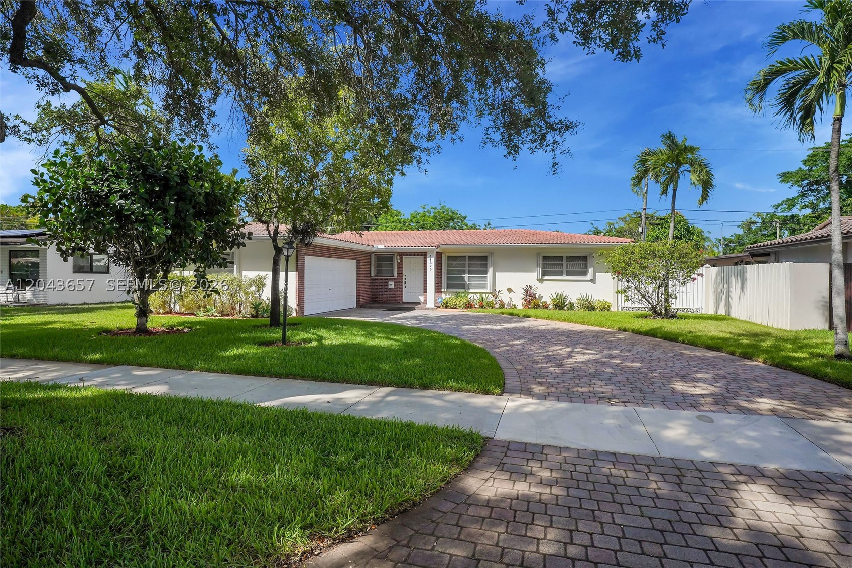 Space, comfort, and location all in one — this warm and inviting 3-bedroom, 2-bathroom home is nestled in one of Miami Lakes' most desirable neighborhoods and ready to welcome you. With approximately 2,200 square feet of actual area including the garage and sitting on an expansive lot of approximately 12,250 square feet, this home offers the space, comfort, and lifestyle that families love.

Step inside and feel right at home. Fresh interior and exterior paint give the home a bright, clean look, while beautiful tiled floors flow throughout every room. The large kitchen, dining and family areas are perfect for entertaining or just enjoying everyday life together. Both bathrooms have been refreshed and are clean, comfortable, and move-in ready.

The spacious two-car garage has been nicely refinished and offers exciting potential to convert into a home office, guest room, or flexible living space. Outside, enjoy an oversized private lot with lush greenery that you can convert into your own dream backyard.

Peace of mind comes standard here with hurricane shutters throughout. No HOA means no extra rules or fees — just freedom to enjoy your home your way.

The curb appeal is undeniable, with ample parking and a welcoming exterior that stands out on the block. And the location? It doesn't get better. You're minutes from Miami Lakes' best parks, restaurants, shops, and top-rated schools.

This one will not last. Don't miss it!