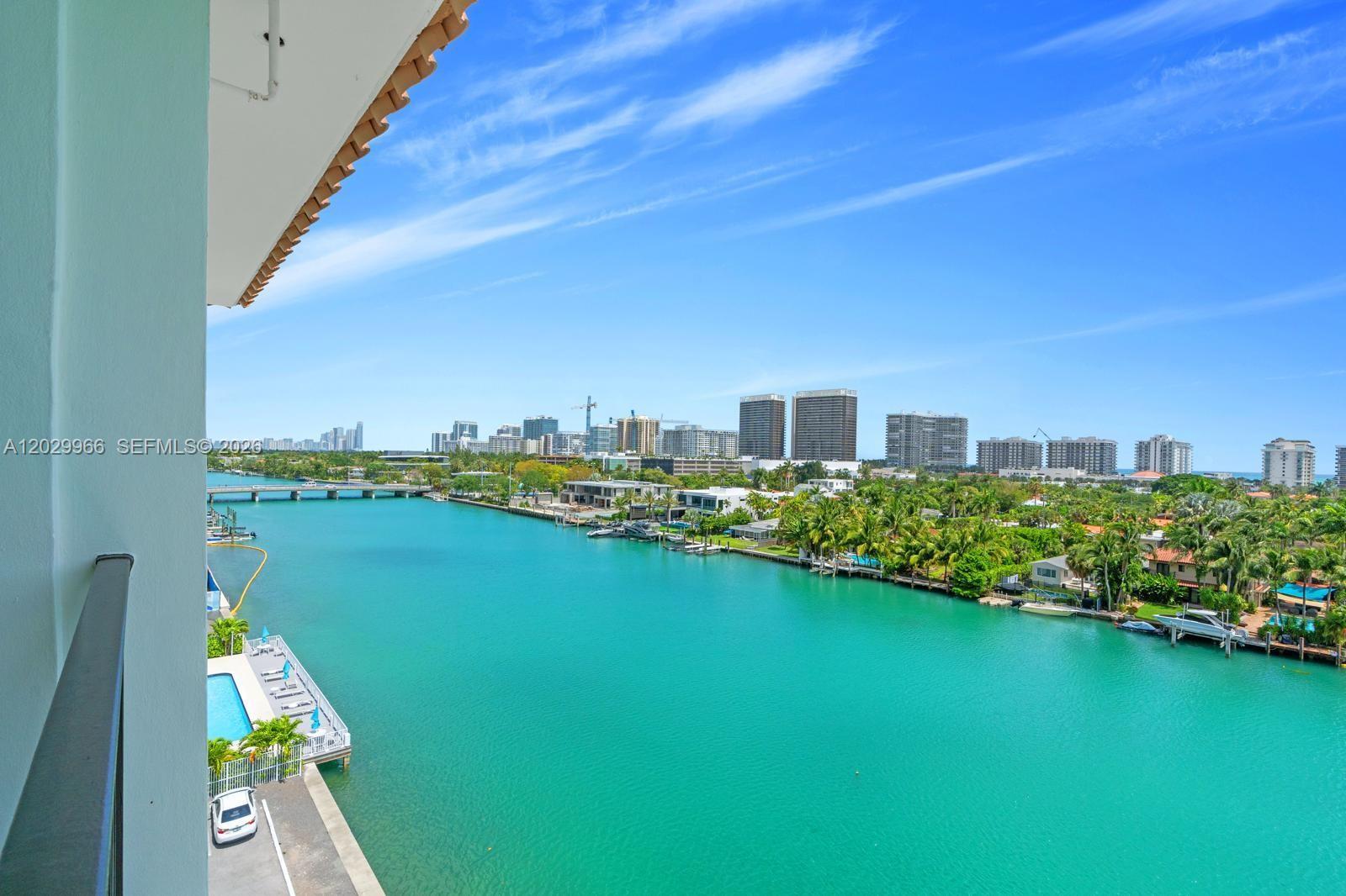 Start your day watching dolphins glide by while enjoying coffee from your private balcony overlooking spectacular water views. This penthouse corner residence offers unobstructed 180-degree vistas of the bay, canal, and city skyline, with a glimpse of the Atlantic Ocean.

Spanning 1,640 square feet, this spacious 2-bedroom, 2.5-bathroom home features oversized en-suite bedrooms with walk-in closets, soaring 12-foot ceilings, abundant natural light, and beautifully preserved original wood floors throughout. The thoughtfully designed interior blends modern elegance with timeless charm, complemented by a European-style eat-in kitchen and a newer A/C system.

Perfectly positioned along the Indian Creek Canal, this boutique waterfront building offers a private pool, assigned parking, and the exclusivity of only four residences per floor. Enjoy a highly walkable lifestyle just moments from the beach, Bal Harbour Shops, top-rated Ruth K. Broad Bay Harbor K–8 Center, restaurants, supermarkets, and more.