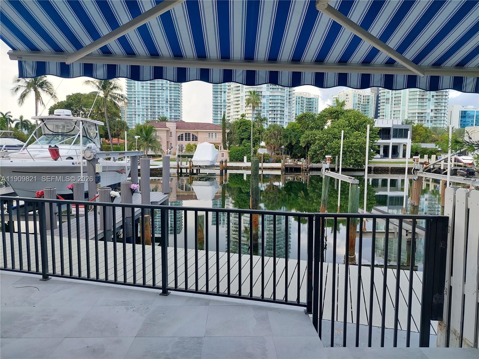 A deed 30'-35' dock, I know where to dock your boat, a Spacious Waterfront Townhome on Poinciana Island. Gated, 3 car parking, 3 bed, 2.5 bath townhome with vaulted skylight ceilings, kitchen, marble floors, and a patio with slate floors and water views. one car garage plus assigned front parking. New roof, impact front door, airy, light-filled interiors. The ocean is across the street. Resort-style amenities include two pools, tennis courts, gym, clubhouse, and 24/7 gated security with patrol.  Water, sewer and trash included. HOA pays insurance, cable, and internet. Island-wide high-speed wireless connectivity, Enhanced security with cameras in all plazas, garages, and along the boardwalk, The location is unbeatable: just 15 minutes by boat to the Bal Harbour Inlet and sandbar and Aventura mall is 15 minutes away.
