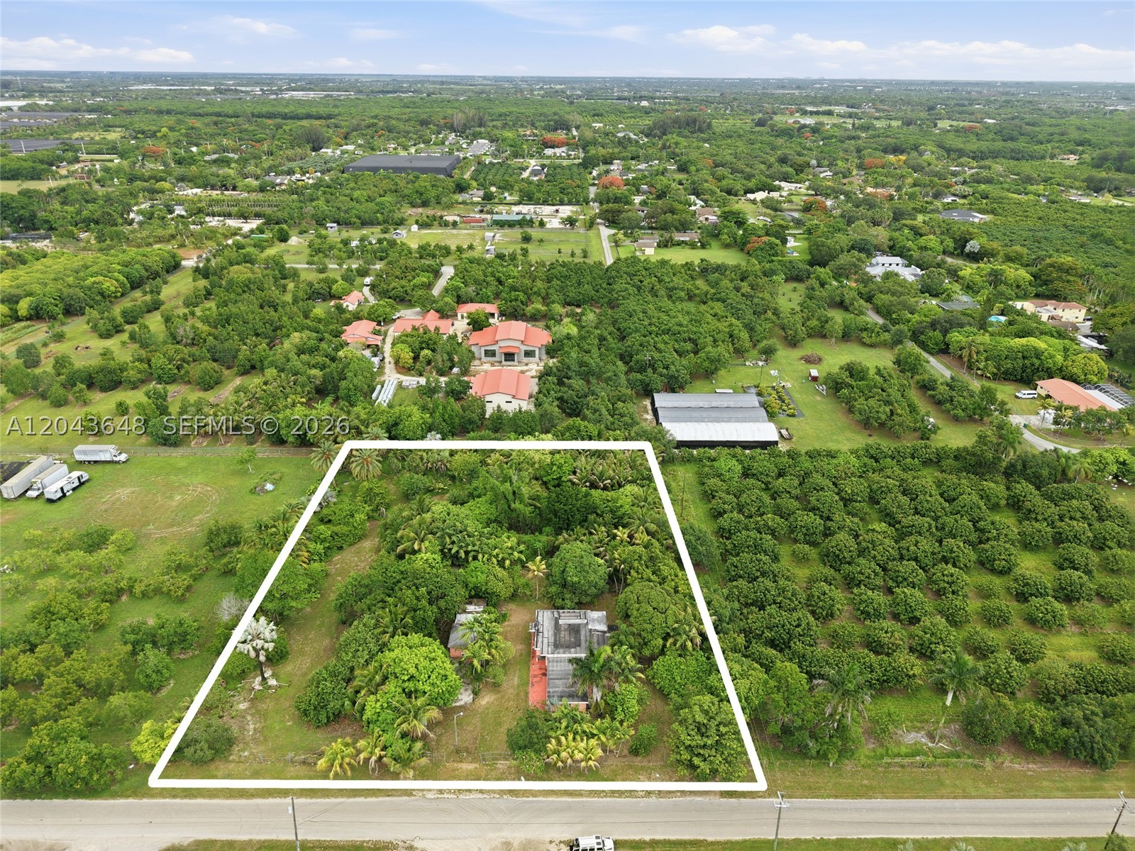 Discover the potential of this 1.94-acre property in the desirable Redland area of Homestead. Surrounded by mature trees, this property features a 2-bedroom, 1-bath home with spacious living areas, an interior laundry room, and a covered patio. A separate detached guest house offers added flexibility for extended family, guests, or rental income. Plenty of room for RVs, boats, gardening, agricultural use, or future expansion. Conveniently located near major roadways, shopping, dining, and schools. A rare opportunity with endless possibilities!