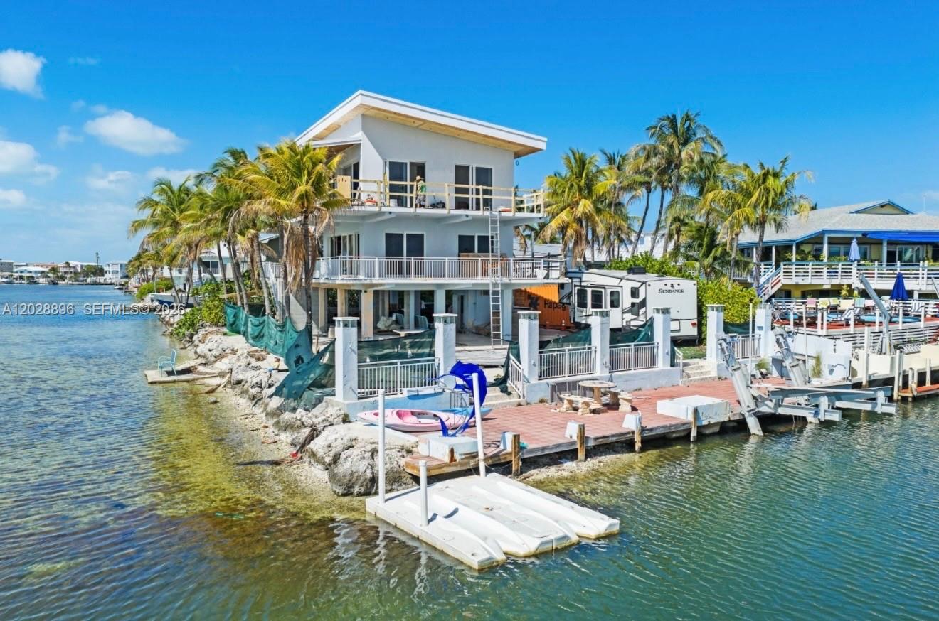 Completely transformed down to the studs and scheduled for completion in late 2026, this extraordinary bay front estate represents the pinnacle of modern Florida Keys luxury. Meticulously rebuilt with elevated design, superior craftsmanship, and today’s most coveted finishes, every detail has been thoughtfully curated to deliver an unparalleled waterfront lifestyle. Experience the ultimate Florida Keys lifestyle in this stunning bay front retreat in highly sought-after Tavernier. Perfectly positioned to capture endless turquoise water views and breathtaking sunsets. This exceptional residence features a raised metal roof, impact windows and doors, designer finishes, and sophisticated modern touches throughout. Designed for the boating enthusiast, the property features a private dock equipped with a 15,000-pound boat lift, providing effortless access to the Florida Bay and Atlantic Ocean. Enjoy a resort-style outdoor oasis with a pool, expansive waterfront entertaining areas, private dockage all overlooking the bay. Just minutes from Islamorada’s renowned dining, marinas, sandbars, and offshore adventures. A rare opportunity to own a newly reimagined masterpiece in the heart of the Upper Keys.