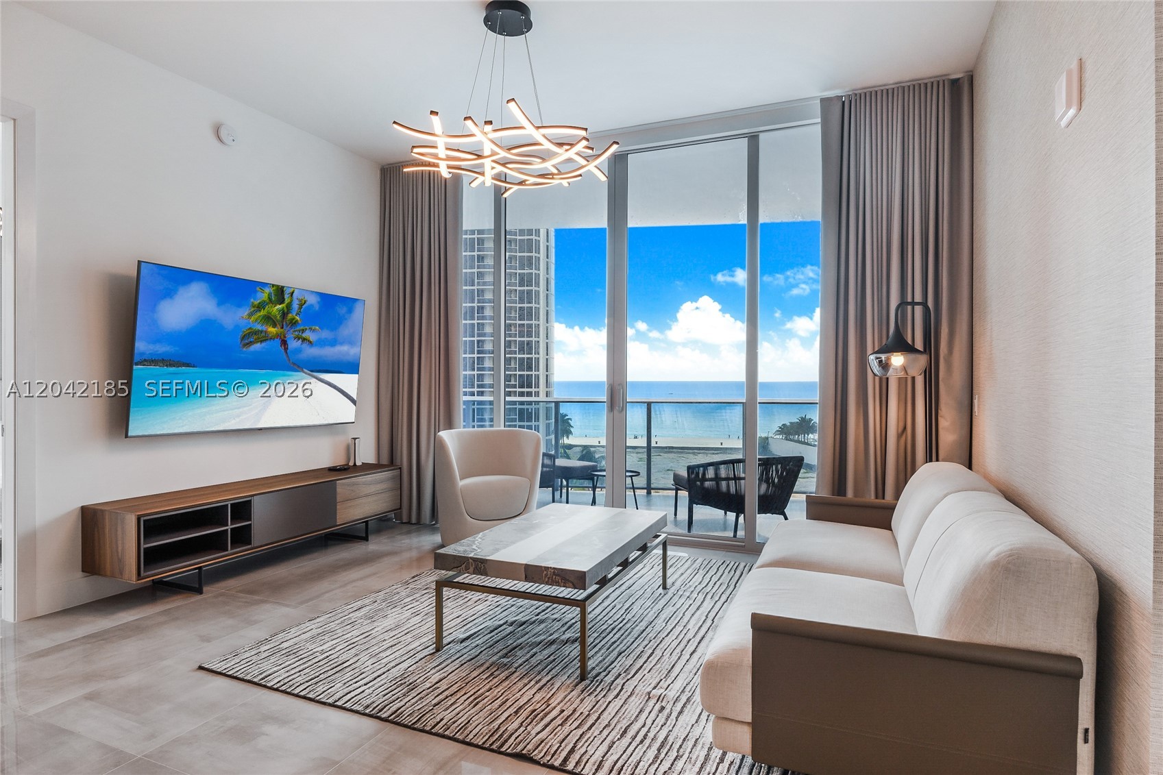 Fully furnished 2-bedroom plus Den and 2.5-bathroom oceanfront residence at Aurora in Sunny Isles Beach. This 1,384 sq ft high-floor residence features a complete interior design by Steven G with all-Italian furniture, motorized shades, and a private keyed elevator foyer. The open living area flows to a private balcony with direct Atlantic Ocean views and the iconic Sunny Isles Beach skyline. Split-floor plan with two en-suite bedrooms and a guest powder room. Building amenities include an oceanfront pool, sauna, fitness center, children's room, business center, dedicated beach service, and 24-hour front desk. Aurora permits short-term rentals with a 30-day minimum, a rare income-producing opportunity in Sunny Isles Beach. Minutes from Bal Harbour Shops, Haulover Beach Park, and Aventura Mall. Turnkey, move-in ready.