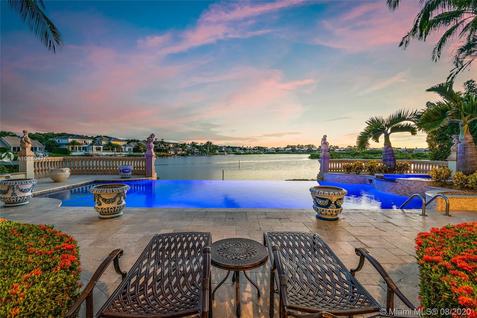 A true masterpiece built by Turtle Beach Construction awaits you. This custom built, thoughtfully designed home has everything one could want. There are multiple places to entertain from the club room with a built in bar to the open great room adjoined to the gourmet kitchen, theater room and summer kitchen that leads to the amazing outdoor space that has spectacular sunsets. You will want to spend countless hours taking in the water views relaxing by the infinity edge pool that feels like it cascades into the panoramic waterway and in the distance a bird sanctuary that is memorizing. Grand formal space, solid marble columns, Venetian plaster, hand painted moldings, high end appliances, a guest house and so much more! This home is sophistication and magnificence at it's best.