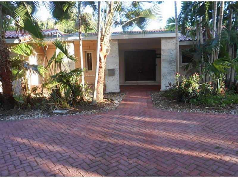 Oversized 3500 sqft home on a half acre lot! Enjoy refinished terrazzo floors, pool with waterfall and a canal view! Owner will give buyer a $30k credit for the kitchen! Make it your own.
