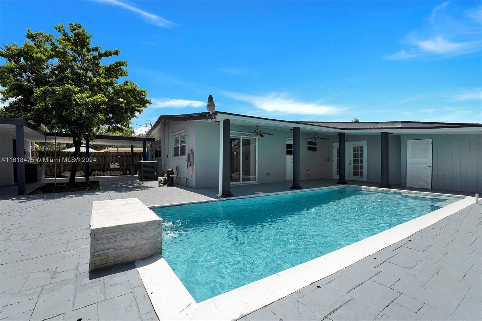 Stunning Pool Home in a desirable family -friendly neighborhood. 3 Br 2 BR- Completely updated throughout in the last few years. plus 1/1 studio that is rented for additional income. Kitchen has a Huge Quartz counter tops, custom cabinets and black stainless-steel appliances with a tap Kegerator. Both bathrooms are tastefully updated. Master bathroom has a cabana door for easy access to the pool. The master closet has a built-in cabinets. Calacatta tile floors throughout. Freshly painted, Stylish rock wall in living room & master bathroom. High vaulted ceilings,  Washer & dryer inside the property. The property has hurricane shutters for protection. Large, covered patio, New roof, new AC,  Pool was re-done in last 5 yrs, Large shed-for storage. Fruit trees