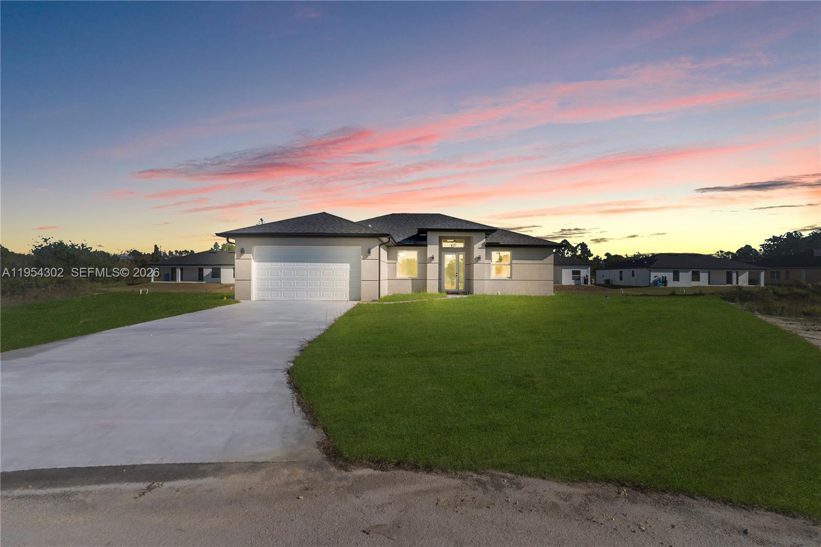 Experience the elegance of brand-new construction in this exquisite 3-bedroom plus den, 2-bath residence tucked away on a quiet cul-de-sac in Lehigh Acres’ peaceful Greenbriar community. Built in 2025, this modern masterpiece showcases soaring vaulted ceilings, gleaming porcelain tile floors throughout, and a bright, open-concept layout that seamlessly blends indoor comfort with outdoor living. The designer kitchen is a true showstopper—featuring sleek quartz countertops, white soft-close cabinetry, stainless steel appliances, and a spacious island perfect for hosting or everyday living. The expansive primary suite offers a serene retreat with dual walk-in closets and a spa-inspired en-suite bath with a glass-enclosed tiled shower and dual vanities. Step through sliding doors to a large covered lanai, ideal for sunset dinners or morning coffee. The exterior boasts stylish modern lines, a two-car garage, and impact-ready windows—all crafted with CBS block for lasting durability. No HOA and just minutes from schools, Veterans Park, shopping, and dining, with easy access to Fort Myers and I-75. A rare blend of style, space, and serenity—this is Florida living redefined.