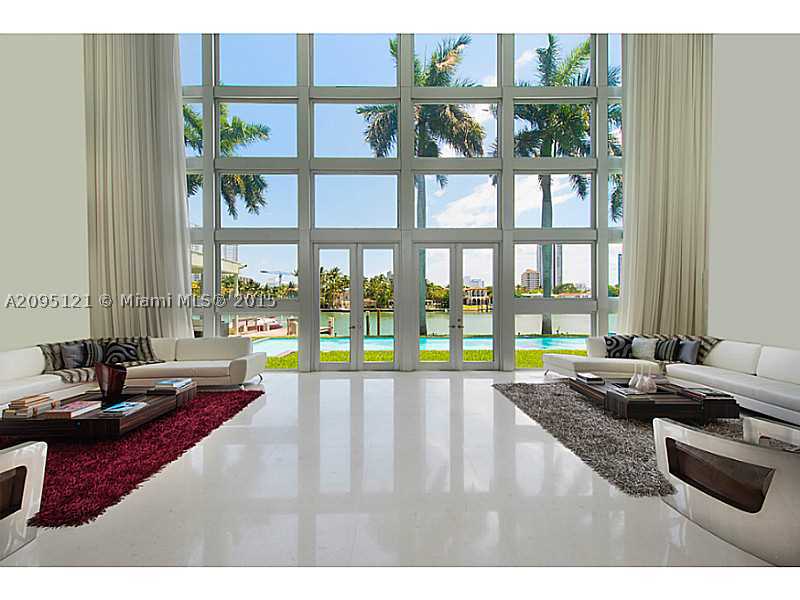 This architectural masterpiece is home to purity of design offering +/-15,000 sf of interior living area. Rich woods, expanses of glass, steel & select marble are lavished throughout this ultra-modern residence that features sky terraces with incredible v iews, 3br guest house and 2-story master suite accessible by a glass elevator. This 3-level estate w/+/-120' of water frontage offers an unmatched lifestyle on La Gorce Island, a private oasis of serenity and breathtaking beauty.