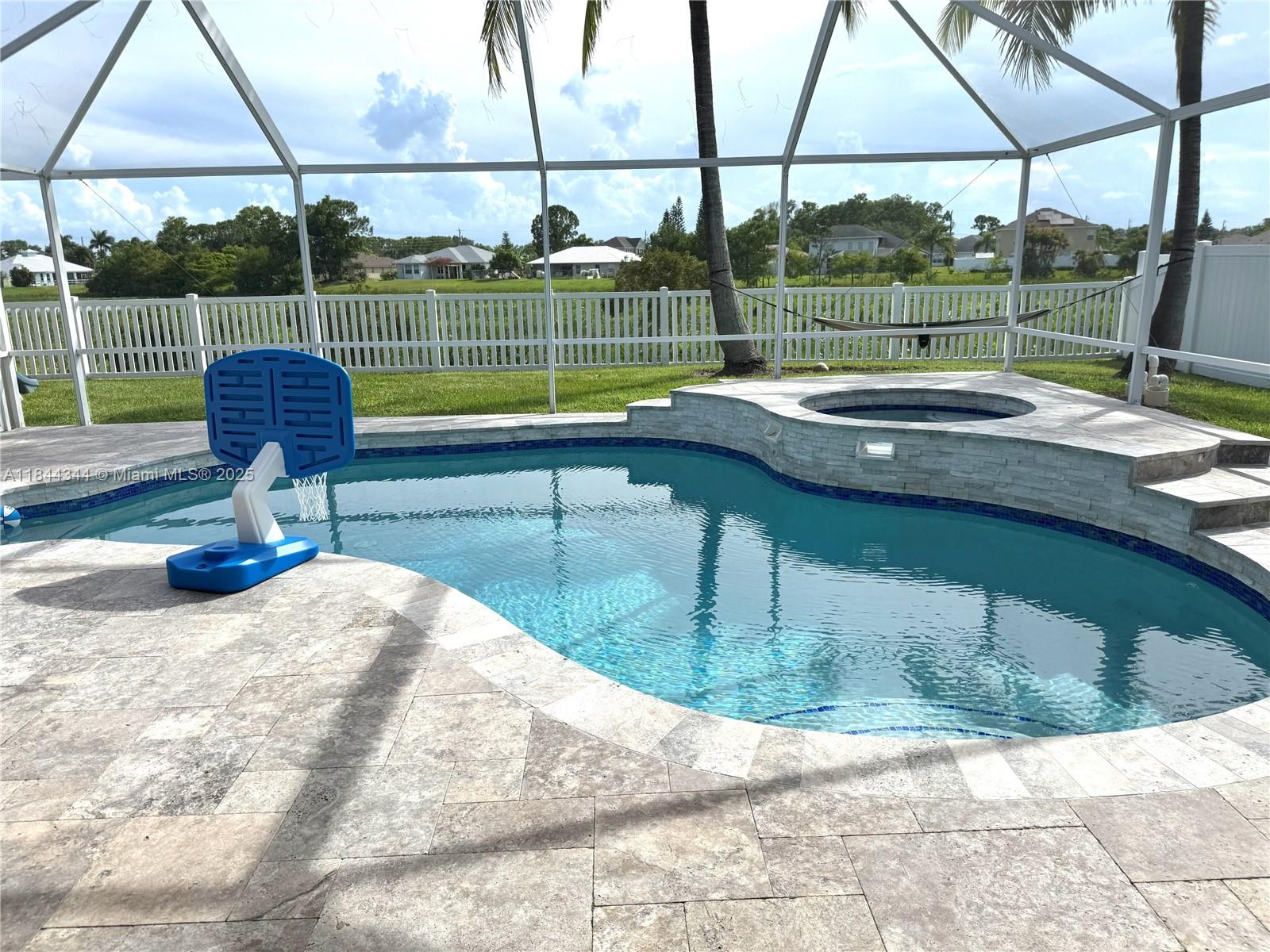 Stunning 4 bed 2 bath home with saltwater pool, jacuzzi and elegant travertine deck redone in 2020, backing to a protected wetlands preserve for ultimate privacy and breathtaking sunset views. This spacious split floor plan includes a versatile flex space, perfect for an office, playroom, or additional living space. Features include a real wood burning fireplace, large hurricane impact sliders, privacy fence, and a brand new roof and gutters completed in July 2025. The open layout is ideal for both entertaining and everyday living with no rear neighbors and tranquil natural surroundings, this is a move in ready home that offers the best of Florida living. A true gem!!