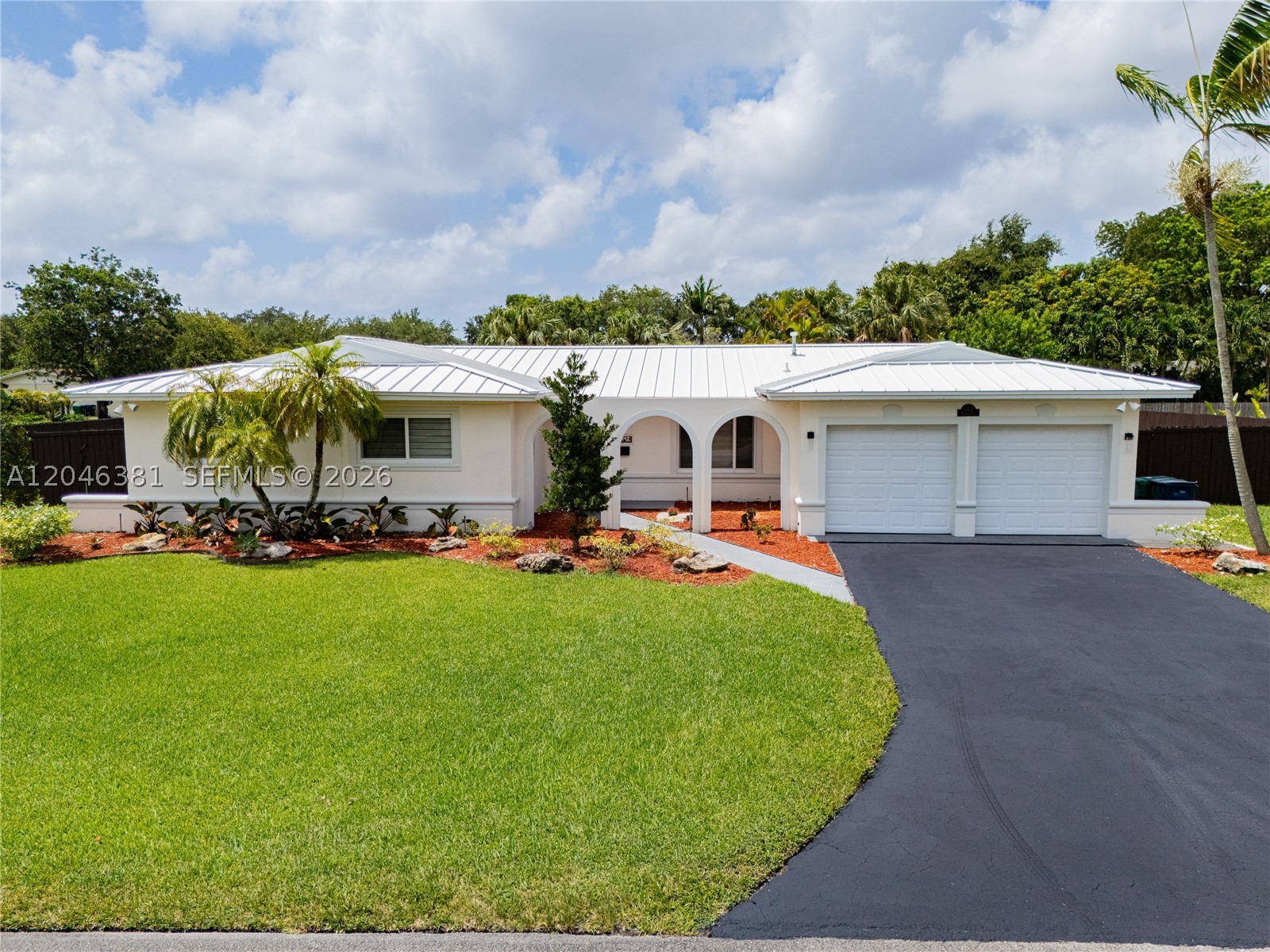 Welcome to this move-in-ready 3-bedroom, 2-bathroom single-family retreat perfectly situated on a sprawling 0.34-acre corner lot. The interior features porcelain tiles, a spacious kitchen with abundant cabinet space, beautifully upgraded bathrooms showcasing custom cabinetry, and zebra blinds throughout. Elegant French doors lead out to a resort-style, fully fenced backyard oasis complete with a covered patio with ceiling fans, a heated in-ground pool, an integrated whirlpool spa, a detached gazebo, and a covered barbecue pavilion.Built with total utility in mind, the grounds feature a large 13'x20' storage shed and an extra-wide gate opening engineered for effortless boat or trailer parking. The oversized 2-car garage acts as a functional extension of the home, fully outfitted with built-in shelving, a utility sink, a secondary refrigerator, and a front-load washer and dryer. Major infrastructure upgrades provide absolute peace of mind, including a full plumbing overhaul in 2013 with PVC and copper piping, electric box upgrade in 2013, metal roof installed in 2013, A/C installed in 2019, a 120 gallon gas tank powering the stove and water heater, front impact glass, and rear accordion shutters. Prime location near major highways, premier shopping, and top-rated A+ schools. No HOA! Seller is offering a 2% credit to buyer on a full price offer!