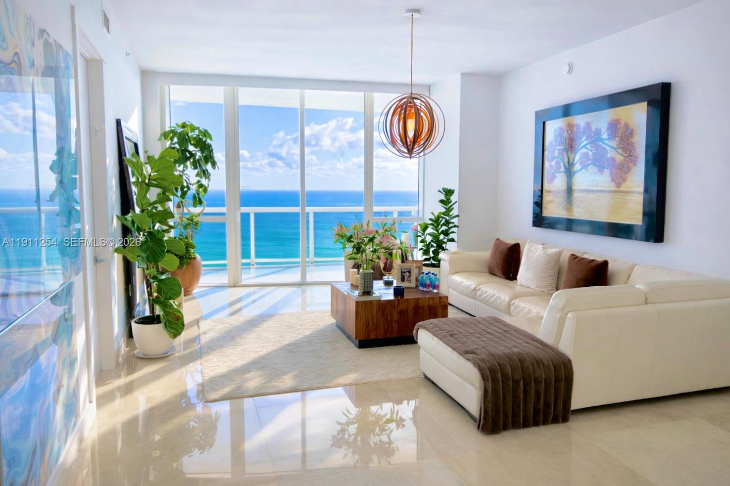 Spectacular ocean views from multiple exposures.  3-bedroom layout potential, den can be enclosed to create a true third bedroom.  Features include floor-to-ceiling windows, 10-foot ceilings, custom-designed closets, and 36x36 marble flooring throughout. The kitchen is fully equipped with premium stainless-steel appliances and granite countertops, complemented by designer bathrooms. Residents enjoy five-star, resort-style amenities including a fully equipped fitness center, heated infinity-edge pools, conference room, and on-site restaurant with delivery service to the beach, pool, and residence. Complimentary beach chairs and umbrellas are provided. Ideally located near Bal Harbour and Aventura Mall.