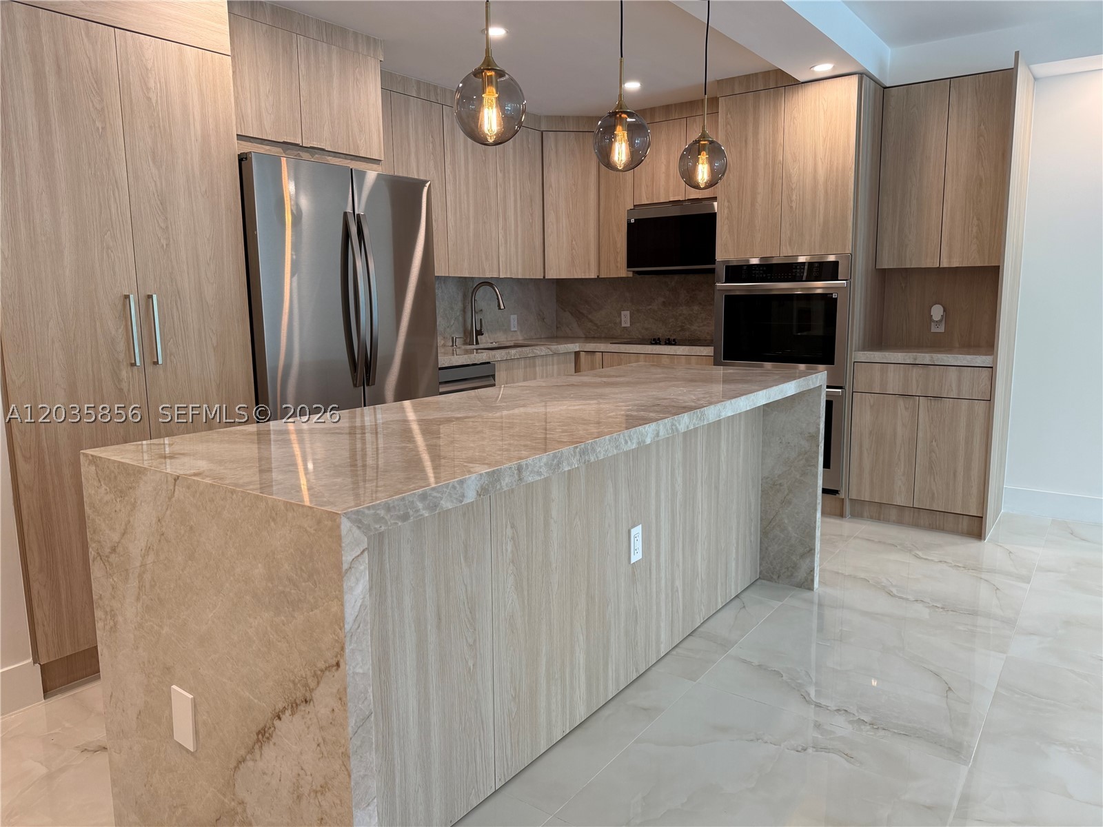 Look no further—this is the best-designed unit in the building. Fully remodeled with meticulous attention to detail by its owners, both designers and contractors. Just steps from the beach, this bright and airy residence is filled with natural light and coastal energy. Features include new impact windows and doors, onyx porcelain floors and bathroom walls, custom closets, in-unit washer/dryer, quartzite island and countertops, a built-in coffee station, and a refined European aesthetic. Every finish was thoughtfully selected for elegance, function, and long-term durability. Seller is willing to contribute toward the special assessment at closing. Minutes from Aventura Mall, top Sunny Isles restaurants, and the area's best schools. A refined transformation built with passion.