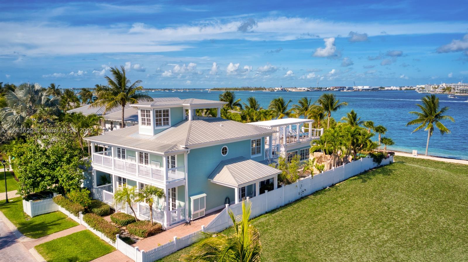 ESCAPE TO PARADSIE! 32 Sunset Key is an oceanfront property with private beach, harbor views facing Mallory Square. The home has a main house and guest house, a combined 3,635 sq ft, total 6 bedrooms all en-suite, 7 full baths. Spacious home has open floor plan with living, dining and kitchen flow into each other. Master suite has separate sitting area w/built in cabinetry/TV. Guest house 2 bdrm, 2 bath, kitchenette, patio. Many upgrades include surround sound system inside/outside, coffered wood panel ceilings, spiral wood staircase, marble floors,crown molding, interior siding board and more. Outdoor kitchen overlooks amazing rock pool/spa, waterfall and 2-story slide loved by all from 9 to 99. Upstairs patio has incredible ocean views. Laundry rm, storage area & carport for Golf Cart.