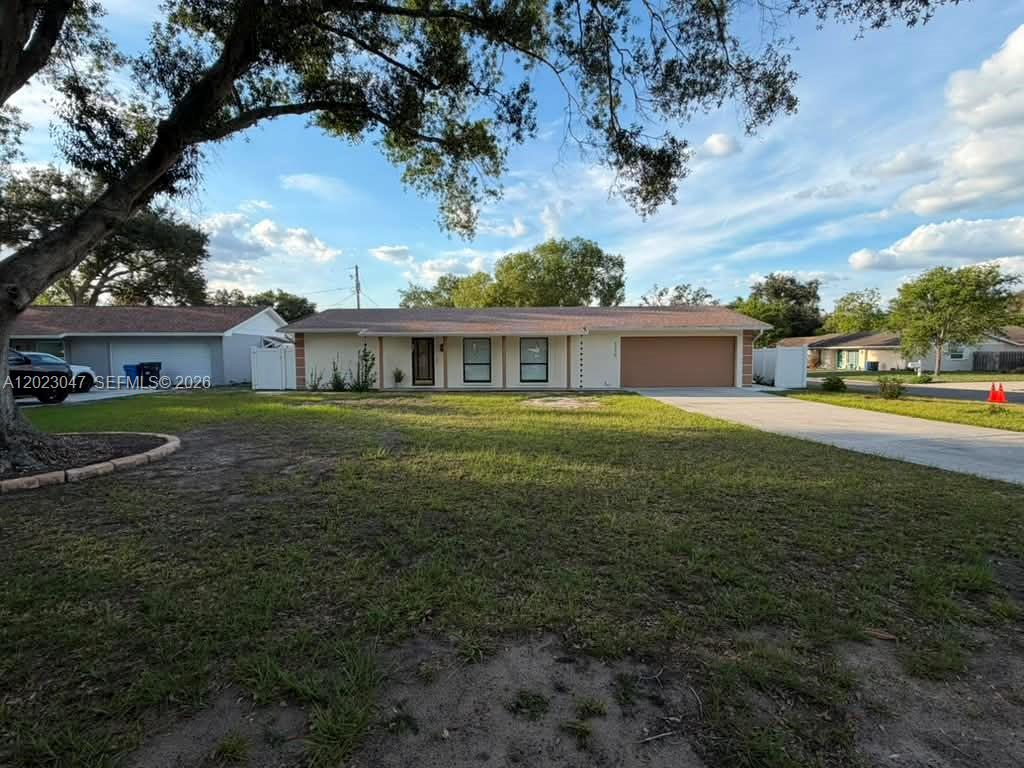 Welcome home! NO HOA!!! This beautifully updated 4-bedroom, 2-bathroom home sits on a desirable corner lot in a quiet cul-de-sac and offers comfort, functionality, and plenty of upgrades. Inside, you’ll find a spacious living and dining room combo filled with natural light, tile flooring throughout, updated LED lighting, and upgraded outlets and switches across the entire home. The galley-style kitchen features stainless steel appliances, corian countertops, and a cozy breakfast nook.The climate-controlled 2-car garage includes its own private entrance, making it ideal for a gym, office, workshop, or flex space. The home also features a tankless water heater, screened-in covered patio, and a spacious 14’x10’ backyard shed with concrete foundation for additional storage or workspace. Enjoy the fully fenced backyard with newly installed PVC fencing, gutters already installed, fresh interior and exterior paint, and a NEW ROOF (2021). The extended side concrete driveway and gated side entrance are perfect for RV, boat, or trailer parking. Conveniently located near shopping, dining, entertainment, and major highways. Move-in ready and packed with value — schedule your private showing today!