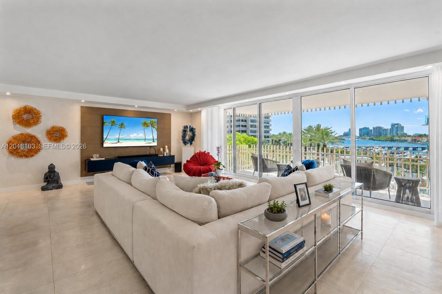 Imagine everything you could ever want just minutes away - yet living here feels like a private tropical escape. This rarely available large 3-bedroom, 2.5 bath Grove Isle residence has been beautifully renovated and professionally designed. Filled with an abundance of natural light, calming neutral tones and a tropical vibe that never gets old. Relax with views of the bay, marina, and downtown Coconut Grove skyline along with incredible sunsets every evening. This is one of the best corner floor plans with 2,424SF of living space and two oversized balconies. The modern open kitchen includes marble countertops, luxury appliances, built-in EuroCave wine storage, pantry, and tons of cabinetry. Additional features are custom built-ins, recessed lighting, impact windows and sliding doors that open wide, motorized shades, and a full-size laundry room with Bosch washer/dryer, sink, and storage. The expansive primary suite offers a large walk-in closet and spa-like en-suite bathroom with dual vanities, privacy water closet, and a spacious shower. Residents that live here enjoy resort-style living with 24hr. security, lobby attendant, two pools, two Jacuzzi's, tiki huts, BBQ's, party room with kitchen, private beach, children's playground, and an island walking path along the bay. Located in one of Miami's most sought-after neighborhoods, just a short drive to Miami Intl. Airport, and stroll or bike to bay-lined parks, marinas, restaurants, cafes, boutique shops, and so much more.