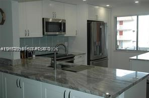 One of the most beautifully designed THREE BEDROOM and TWO BATHROOMS condo in a 55+ community. This property has a tastefully designed chefs kitchen with a lazy susan and spice slide out and ample break front storage for your holiday dinnerware and regular dinnerware. Newer HVAC unit, new water turn off in the unit, new flooring, new GE profile washer and dryer WITHIN the unit in the AC, new GE refrigerator and stove. Unit is located at the end of the walkway. Community is primed for a cash infusion from investors in the surrounding golf course.