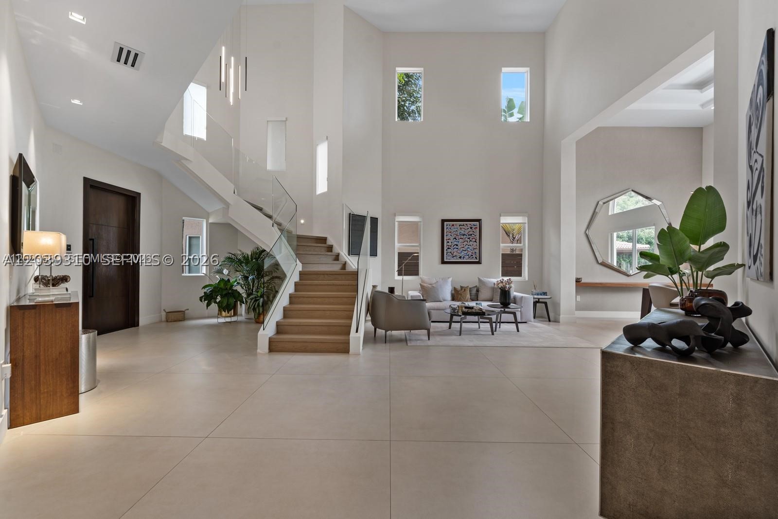 Experience luxury living in prestigious Venetia neighborhood of Doral Isles. This completely remodeled, move-in ready, residence features stunning 48x48 porcelain tile flooring, while the staircase and entire second floor are finished with elegant imported oak wood flooring throughout. Designed with exceptional attention to detail, the home showcases, glass railings, smooth walls with level 5 finish, marble and porcelain bathrooms with custom vanities and countertops. The kitchen, designed by Porcelanosa, is quipped with premium built in Sub-Zero and M series, black glass, Wolf appliances package with a full length wine fridge. Enjoy ultimate in privacy with no backyard neighbors, Chicago brick deck, ample pool, and cabana with a full outdoor kitchen—perfect for entertaining. Additional upgrades include a fully automated Lutron lighting system throughout the home, Alarm system, and built in speakers in the living area. A truly exceptional property for buyers seeking luxury, comfort, and turnkey living in one of Doral’s most desirable communities.