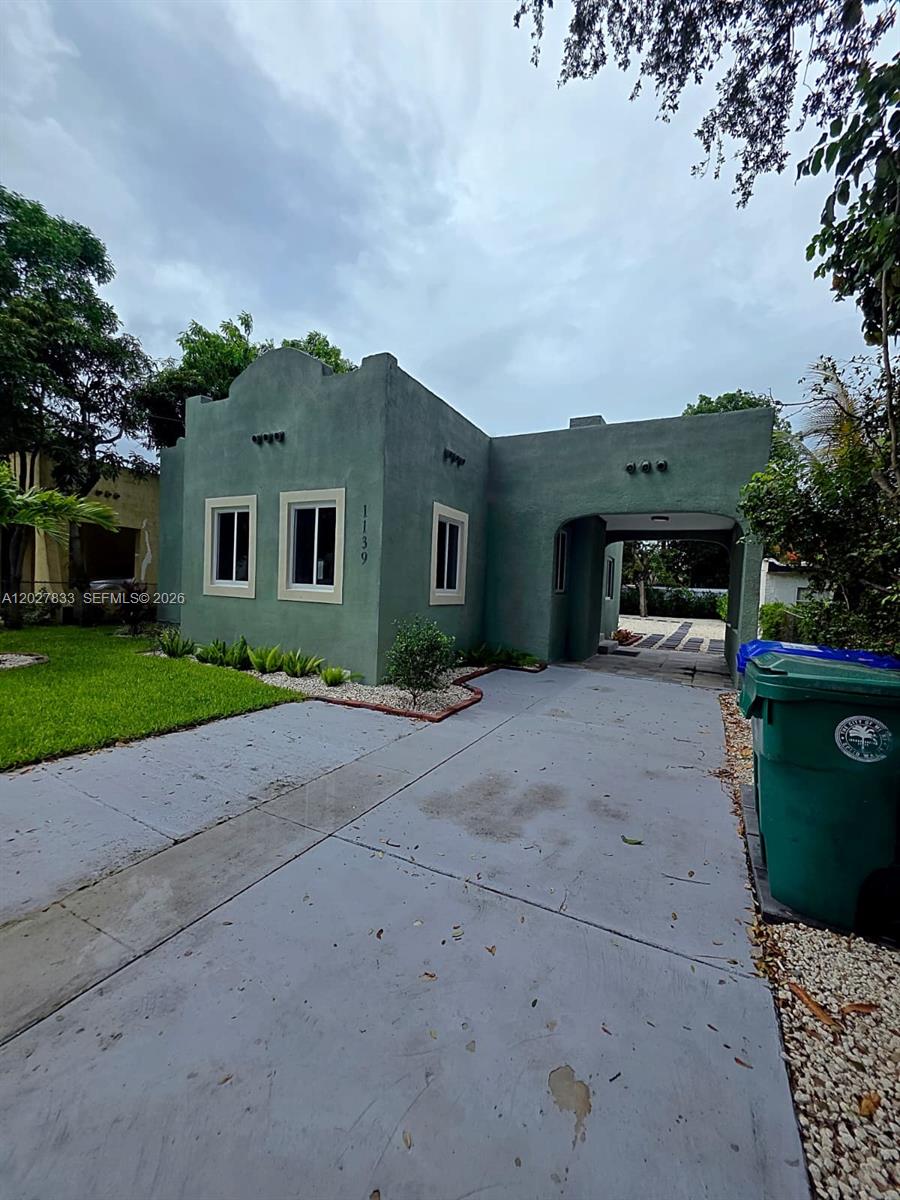 Beautifully updated Old Spanish-style home in the heart of Allapattah featuring classic arches throughout and a charming fireplace that add warmth, character, and timeless appeal. This 2-bedroom, 1-bath residence also includes a versatile den that can serve as a third bedroom, home office, or flex space. Offering 1,202 square feet of living space, the home features a bright and open layout, a spacious kitchen with new appliances, a dining area, and impact windows and doors throughout. Situated behind a gated entrance with a newly installed rolling front gate, this property offers added privacy and security. Step outside to a beautifully landscaped, oversized backyard that is perfect for entertaining, family gatherings, and outdoor enjoyment. Fully fenced for privacy, the expansive yard provides plenty of room for children and pets to play while offering endless possibilities for future expansion. With no major trees limiting development, the property can accommodate a guest house, income-producing unit, pool, outdoor kitchen, or additional living space. Zoned T3, it offers exceptional flexibility and future development potential for homeowners and investors alike. Additional improvements include updated electrical, a recently serviced central A/C approximately 5 years old, and a roof estimated to be 10 years old. Ideally located just minutes from Wynwood, the Design District, Downtown Miami, the Health District, Miami International Airport, major highways, shopping, dining, and schools. A rare opportunity to own a move-in-ready home filled with Old Spanish charm, modern upgrades, and future upside in one of Miami's fastest-growing neighborhoods.
