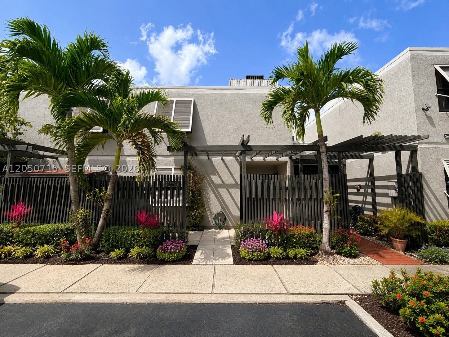Welcome to this beautifully designed Pembroke Pines townhouse with a charming front porch entry, serene lake views, soaring wood vaulted ceilings, and a bright, open-concept layout. The main living area is filled with natural light from a dramatic wall of sliding glass doors that opens to a spacious screened patio overlooking the water. The kitchen features stainless steel appliances, stone countertops, high-hat lighting, and an island overlooking the living room and lake view. The flexible floor plan offers one bedroom and one full bathroom downstairs, with the primary suite and third bedroom upstairs sharing a full bathroom. The spacious loft-style primary suite overlooks the living area below, adding openness, character, and architectural charm. Additional features include an upstairs washer/dryer, newer A/C (2021), newer roof (2023), and tankless water heater for added storage space. Conveniently located near Pembroke Lakes Mall, Publix, Memorial Regional Hospital, and major highways. The community offers 24-hour security, a pool, tennis courts, basketball courts, and racquetball, providing plenty of amenities to enjoy. *Photos may be virtually staged and or digitally modified for marketing purposes and may not reflect the property’s current condition. Buyer to verify all property features, condition, dimensions, improvements, and financing eligibility, including FHA and VA eligibility.