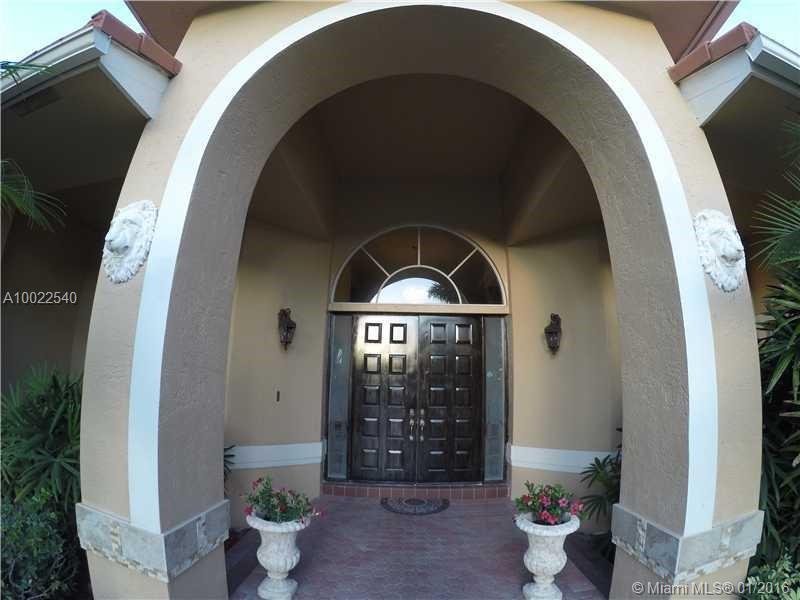 Fabulous private/gated estate home that exudes prestige and distinction.  Greeted by lush landscaping, soaring royal palms, fountain & circular driveway, all on builders acre.  This home boasts 5,300 sq ft LA & 6,200 sq ft TA.  Volume ceilings throughout, features 4BR/4BA Plus office and huge bonus room/gym with 3 car garage.  Tasteful décor & designer style with stunning columns, newer kitchen & carpets.  Pool and Spa, covered gazebo w/gas line summer kitchen sitting a canal water view.  Low hoa!