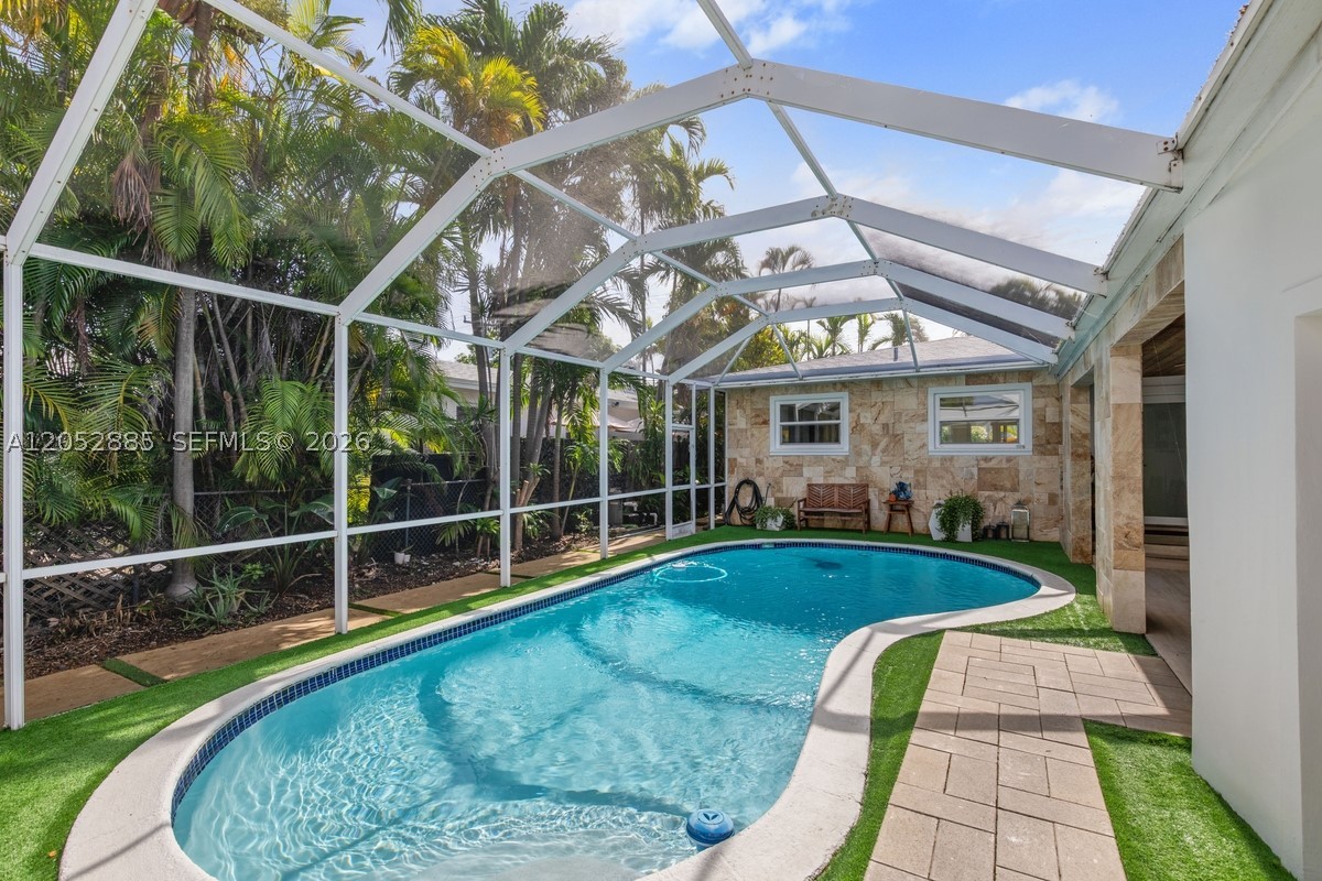Beautifully reimagined residence in one of South  Florida's most dynamic and rapidly evolving waterfront communities! This exceptional move-in ready home has been renovated throughout and features a new roof, impact-rated windows and doors, updated pool equipment, custom kitchen cabinetry, and beautifully redesigned bathrooms. Every detail has been carefully curated to deliver a seamless blend of timeless style, modern comfort, and lasting quality. Filled with natural light, the open-concept living spaces create an inviting atmosphere ideal for both everyday living and effortless entertaining. Step outside to a private backyard oasis featuring a sparkling pool, offering the perfect setting to relax, entertain guests, or enjoy South Florida's year-round outdoor lifestyle!