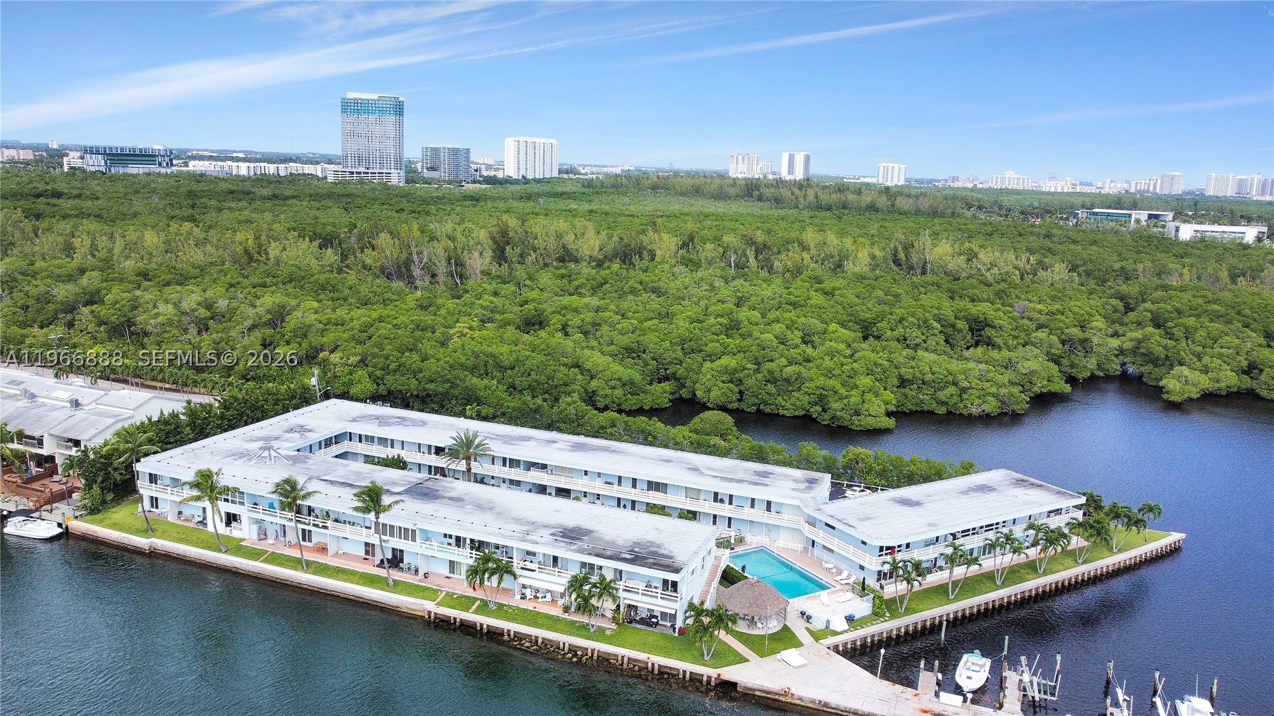 Experience refined waterfront living in a true resort-style setting with breathtaking, wide-open views of Biscayne Bay. Enjoy effortless boating with no fixed bridges and quick access to Haulover Cut, or embrace nature by kayaking directly into the pristine Oleta River. Spend your days fishing from the private pier or unwinding by the waterfront pool while soaking in spectacular bayfront scenery. This exceptional and rare offering features a residence with a private dock, within the exclusive gated Fairmont House community. The unit boasts creating an expansive indoor-outdoor living experience ideal for entertaining or relaxing while enjoying the bay breeze. Residents enjoy a serene, low-density waterfront lifestyle with lush landscaping, secure entry, and a peaceful ambiance rarely found in South Florida. Ideally located just minutes from beaches, dining, shopping, and major roadways, this home offers the perfect balance of privacy and convenience. Easy to show—call for instructions. Cash or special financing for co-op purchases only. No rentals permitted for the first 2 years.