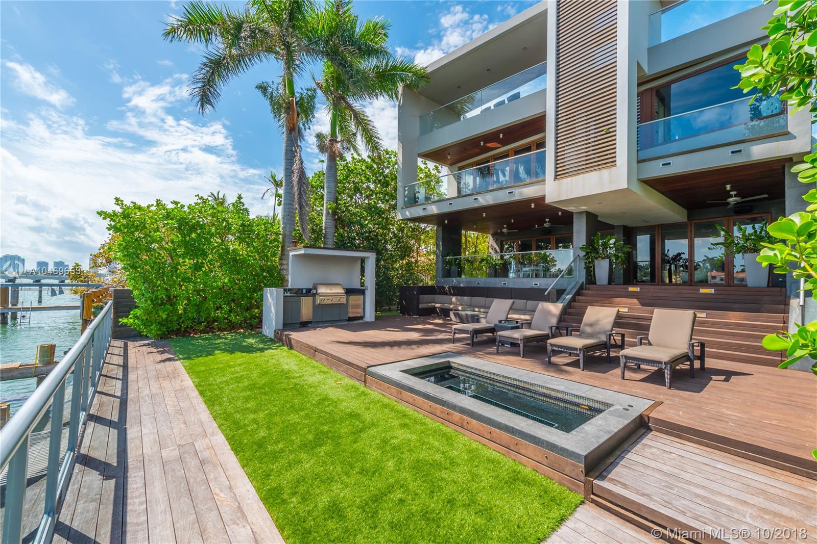This one-of-a-kind tropical modern oasis was masterfully designed to resemble a luxurious yacht. Impeccable finishes and 20 ft glass windows spanning the entire width of the home were made to blur the line between indoors and outdoors. Expanses of glass, rich Rosewood finishes and stunning water views set the tone for a serene living experience offering modern sophistication in one of the city’s most coveted islands. Features include 5 BD, 4 +1 BA, 6,607 adj sf of interior living space, 53’ on the water, polished volcanic stone floors, interior glass and steel stairway, and a 1,500 sf rooftop deck that sports a pool, bbq & sunset views over the Downtown skyline. Caesarstone surfaces in the gourmet open kitchen & floor to ceiling windows in the master suite offering breathtaking bay views.