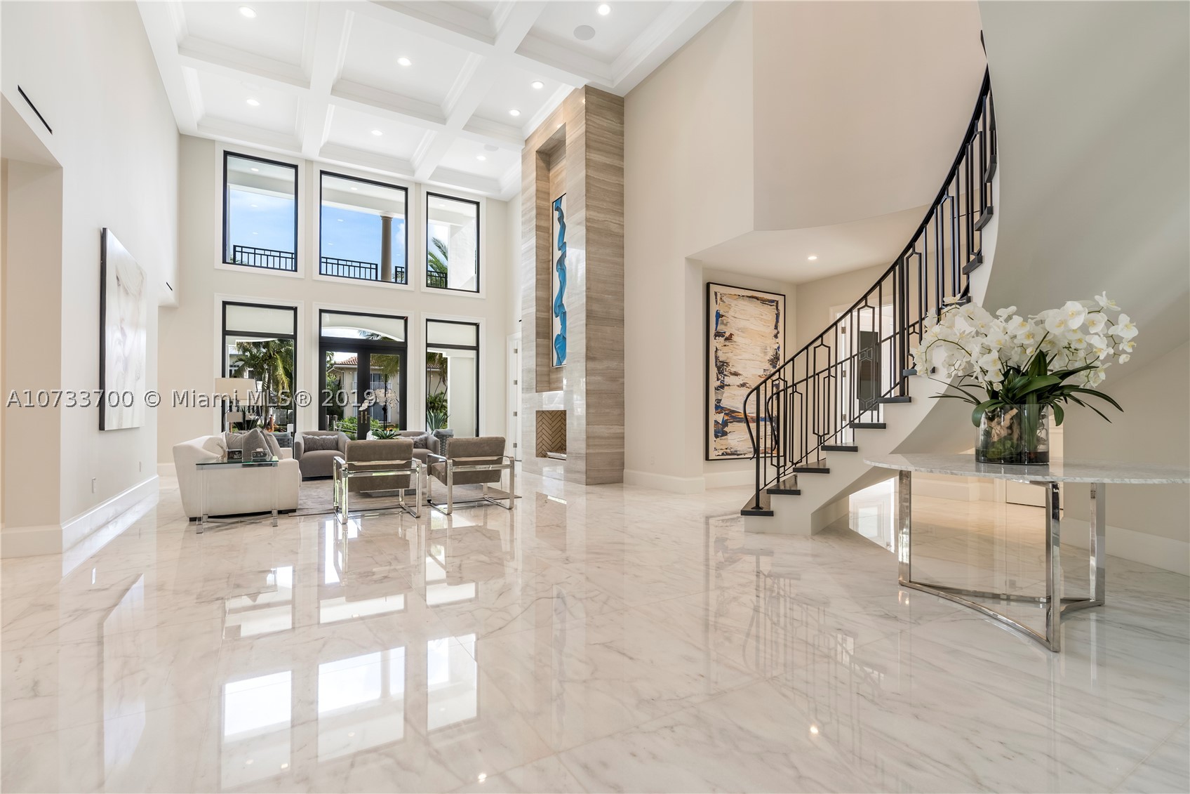 Come see the difference between this quality NEW custom built home versus a spec home. Gated waterfront estate with 75' waterfront, 3-story CBS, 5 bedroom/5 bathroom/1 half bathroom, Master bedroom suite on the 1st floor and 2nd floor, magnificent 3rd floor bonus room with Intracoastal waterway views, elevator, media room, floor to ceiling glass wine room, floor to ceiling gas fireplace, 36x36 marble throughout, 45x15 salt/heated pool with (gas) fire and water features. New concrete dock/pilings extended to 11' from seawall with new coral reef for turtles and sea-life. Cell phone controlled lighting/smart home, Hurricane impact windows and doors, 3-story foyer with spiral Italian wood staircase. Not a detail was missed on this custom home! A must see!