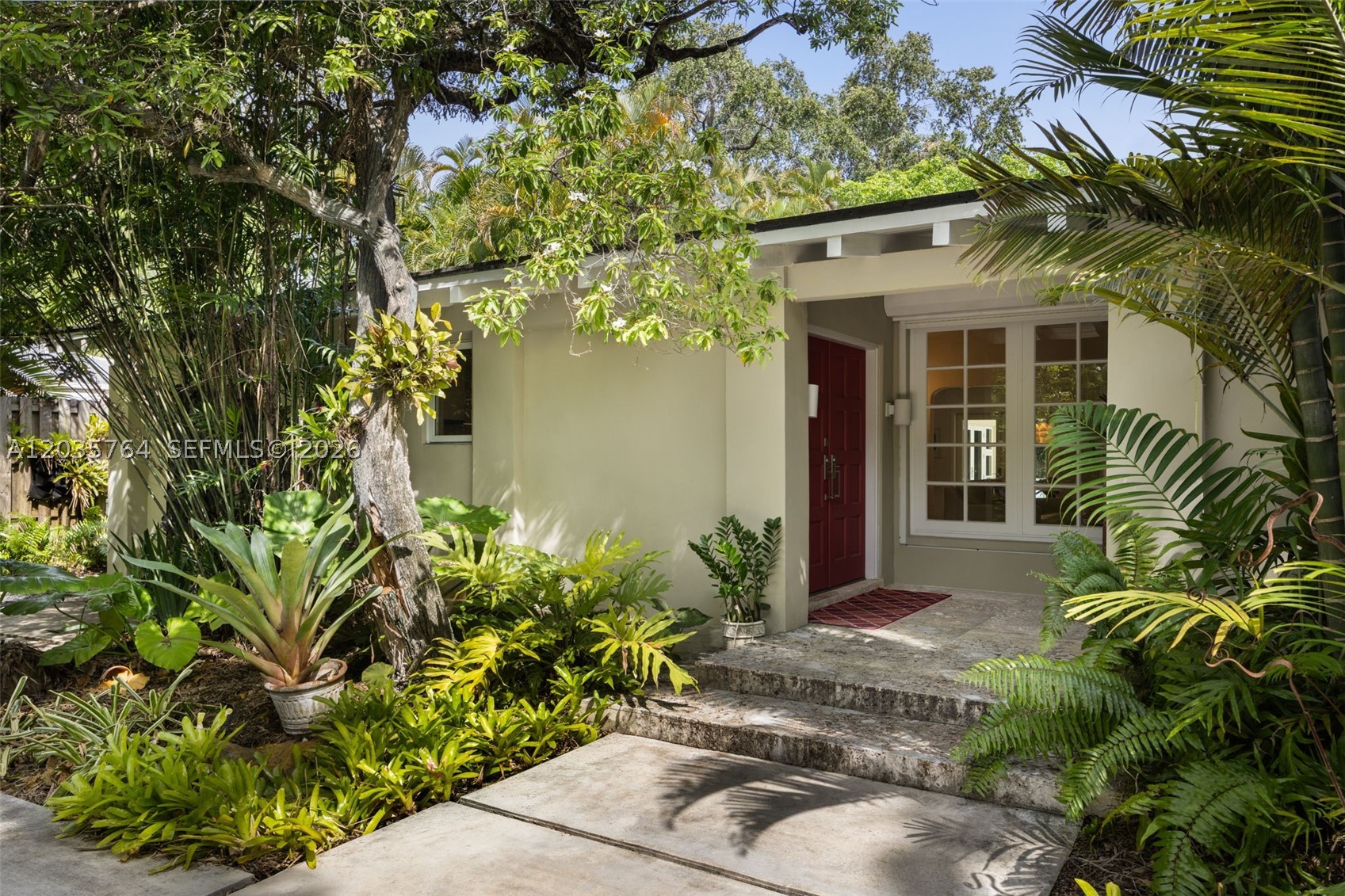 Nestled on a quiet street in the sought-after Natoma Manors neighborhood, this light-filled one-story residence offers a thoughtfully designed 3-bedroom, 3-bath split floor plan on a private 11,000 SF lot. A gated circular driveway with EV charger creates a welcoming arrival, while expansive windows and doors fill the home with natural light and connect seamlessly to the outdoor living spaces. The chef’s kitchen is equipped with a Thermador double oven, Sub-Zero refrigerator, and gas range, making it ideal for both everyday living and entertaining. The spacious primary suite opens directly to a covered Ipe wood deck and pool area, creating a peaceful retreat surrounded by lush landscaping. Outdoors, enjoy a beautiful pool, a tranquil pondless water feature, and a thoughtfully curated collection of native plants designed to attract pollinators. Additional features include city gas service for the 11KW backup generator, range, and BBQ grill, along with a garage providing valuable storage space. Natoma Manors residents benefit from buried power lines, sidewalks on both sides of the street, and a private roving police patrol, all within one of Coconut Grove’s most established residential enclaves.