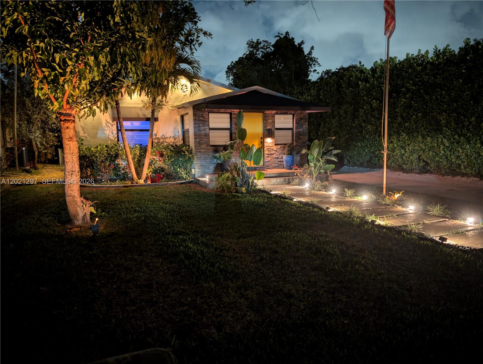 Welcome home to this impeccably updated and spacious 2-bedroom, 1-bath, 1-car garage residence situated on a highly desirable quarter-acre lot in the heart of Hollywood. Perfectly positioned for the ultimate South Florida lifestyle, this turnkey property offers easy access to the pristine sands of Hollywood Beach, the vibrant Broadwalk, and the bustling dining & entertainment of Downtown Hollywood. Step inside to find beautiful, continuous, original "Dade Pine" flooring and spaces flooded with natural light, all heavily secured by full hurricane-impact windows & doors. A true standout is the bathroom, featuring meticulously tiled walls and high-end finishes. Brand-new Daikin A/C system, brand-new whole-house water softener and alkaline hydrogen water system. Fully equipped with a dedicated Tesla EV charger. Unique, hand-painted garage mural. Looking for a seamless move? Furniture is available for purchase. The massive 0.25-acre lot offers the new owner a sprawling canvas with endless potential to add square footage, a custom pool, outdoor kitchen, or even an Accessory Dwelling Unit (ADU). "X" (no flood) Zone. Whether you are looking for a tech-forward haven, a stylish, worry-free sanctuary, or a property with massive lot potential, this Jackson Street gem delivers on every front.