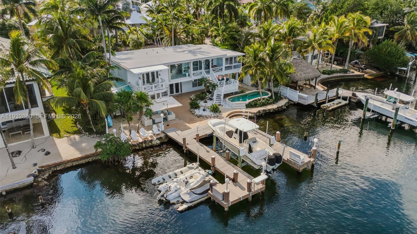 Stunning bayfront retreat in a sought-after subdivision of Key Largo, MM105.5, offering privacy, abundant natural light, and a refined Florida Keys lifestyle with convenient access to Miami. This contemporary waterfront residence features an open, airy layout with 3 bedrooms and 4 bathrooms, spacious studio and in-laws quarter- both its own entrance designed for comfort and relaxation.

The sleek, modern kitchen flows seamlessly into expansive living areas, creating an ideal setting for entertaining or everyday living. Large windows frame endless open-water views, while generous indoor-outdoor spaces invite you to enjoy poolside living and breathtaking bayfront scenery.

Boating and fishing enthusiasts will appreciate the new private dock with a 13,000-lb boat lift, perfectly suited for a 27-ft Boston Whaler. The boat is also available for purchase, offering a turnkey waterfront lifestyle with direct bay access and easy ocean access. A rare opportunity for those seeking modern design, open water, and exceptional boating in the Florida Keys.
