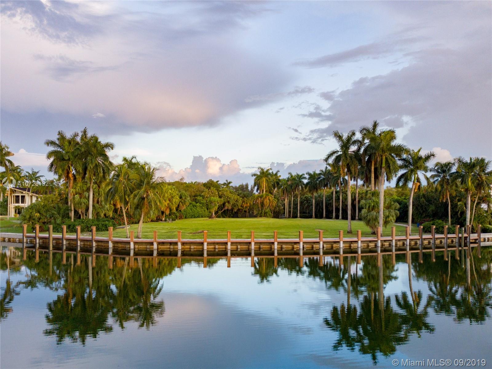 The largest lot available in guard-gated Gables Estates, the most exclusive neighborhood in Coral Gables!! This WATERFRONT property is roughly 2 acres with 325 linear feet on the water facing a wide canal, spectacular sunset views, and a calming breeze when hanging out in your future backyard. This lot is being sold with FULLY APPROVED plans and permits by renowned architect Cesar Molina. A new seawall structural cap and dock were just completed saving the new owner time and money. The new dock accommodates up to 2 mega yachts. This property also features membership in the newly built Leucadendra Tennis Club Center – which is only available to a few owners. This is a one in a lifetime opportunity to buy the largest lot available in Gables Estates!!