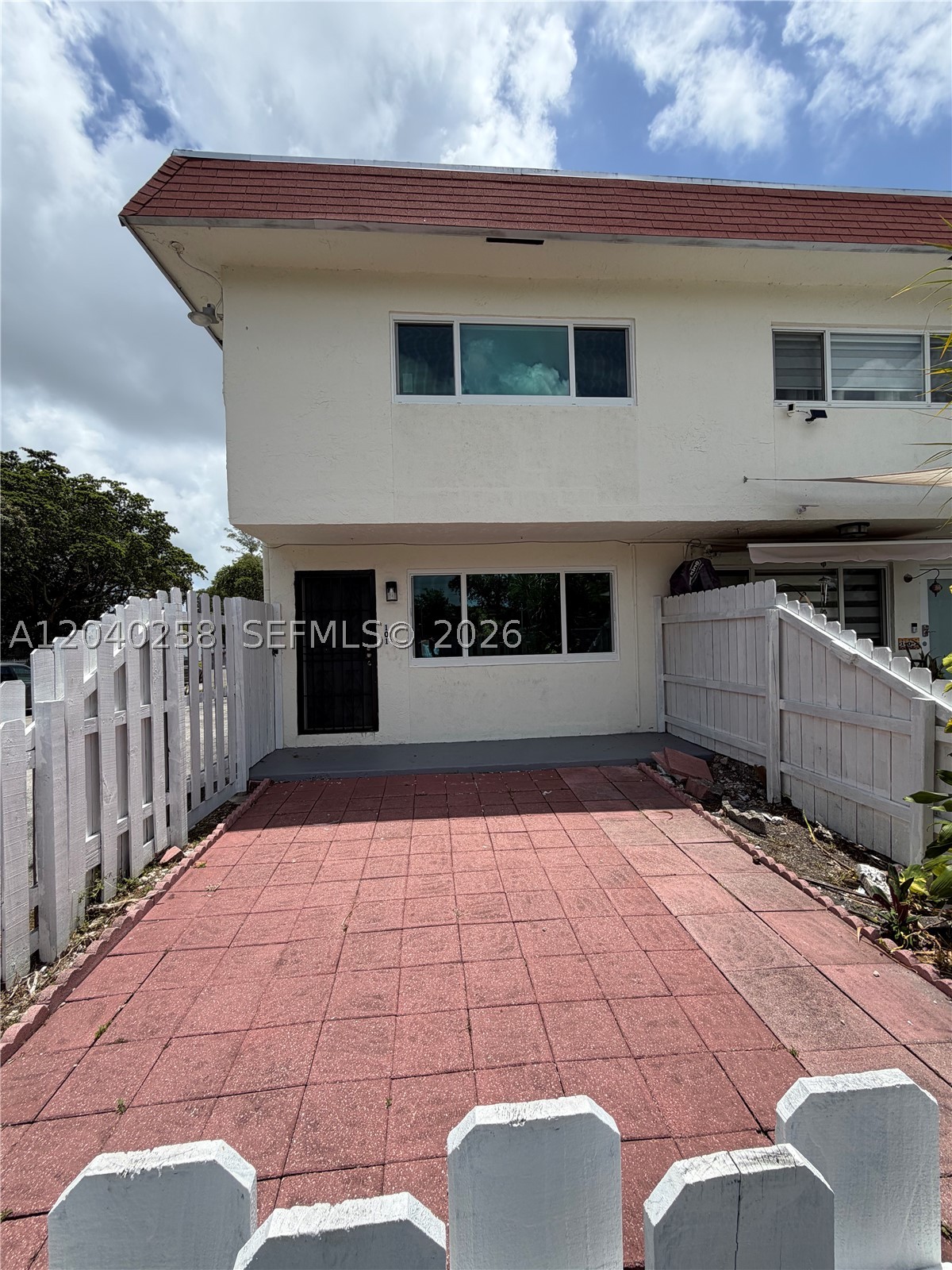 Beautiful 2-story townhouse for sale at 1450 NE 151st St #101, Miami, FL. This move-in ready home features 2 spacious bedrooms and 1 full bathroom upstairs, plus a convenient half bathroom on the first floor. Enjoy a bright and functional layout with plenty of natural light, impact windows throughout, and a private front patio along with a fenced backyard—perfect for relaxing, entertaining, or creating your own outdoor retreat.

Additional features include washer and dryer hookups, 1 assigned parking space, and a desirable location close to shopping, dining, schools, and major highways. Whether you're a first-time homebuyer, investor, or looking to downsize, this charming townhouse offers comfort, convenience, and great value.

Don't miss this opportunity to make this beautiful property your new home!