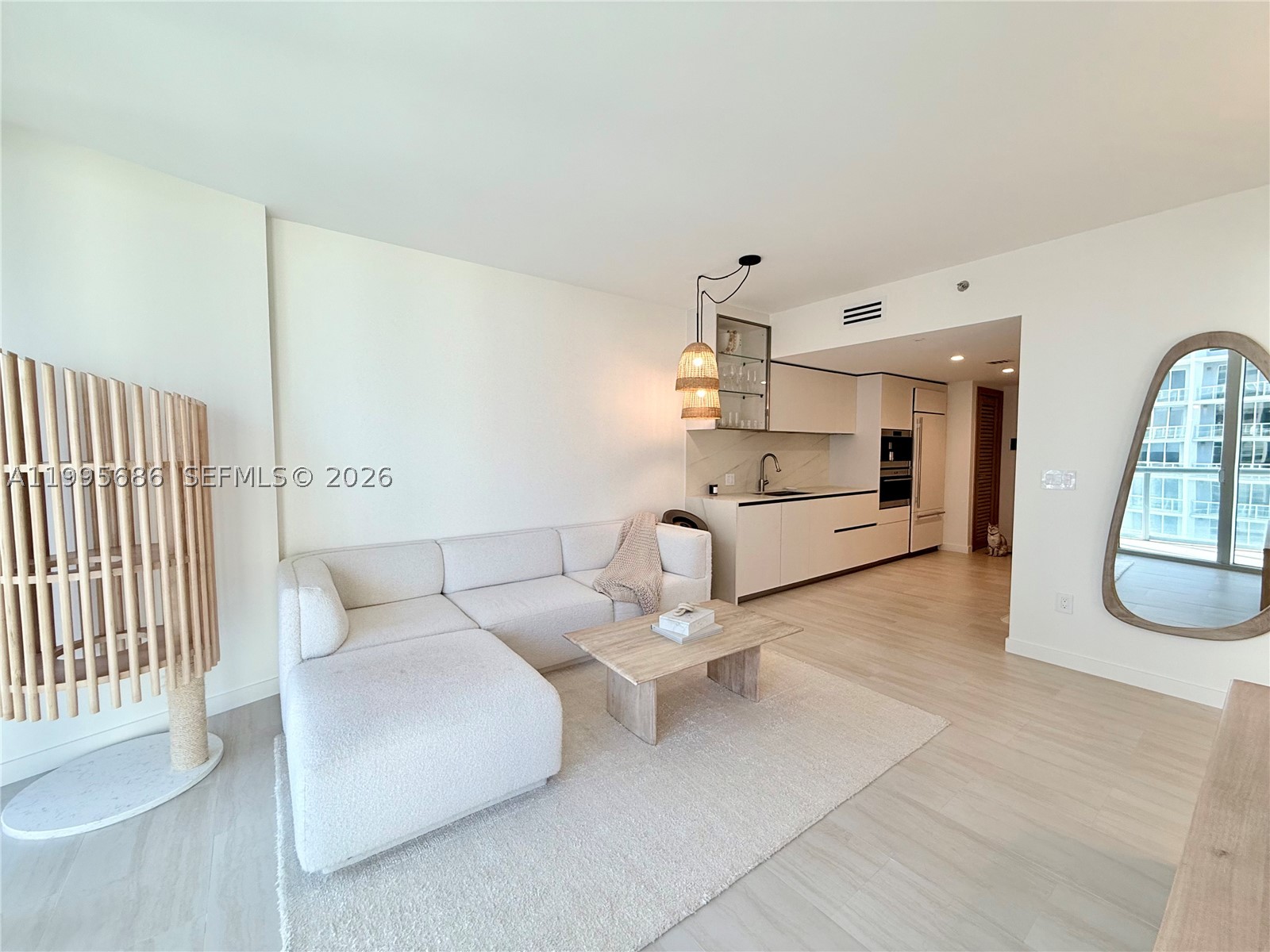 BRING YOUR SUITCASE! Perched on the 51st floor, this renovated, fully furnished, turn key residence offers sunrise and waterfront views high above Brickell. Every detail was intentionally curated—from Sub-Zero/Wolf appliances and custom cabinetry to the invisible induction cooktop—creating a minimalist sanctuary that blends warmth with sophistication. Large-format porcelain floors, integrated smart home system, cerused white wood and boucle furniture creates a clean neutral palette that elevates the space. World-class amenities include a spa, fitness center, 1-acre pool deck, and more—within one of Brickell’s most iconic addresses by Philippe Starck with seats to Bayfront Park’s fireworks from the comfort of your home. Financing for primary residence as low as 10% down with preferred lender. View not affected by upcoming 75-story Nobu tower. Stucco project underway but NO special assessment with completion slated for Oct-Dec 2026. Cats, cat tower/bed and air purifier in living room excluded from sale. Owner/Broker/Designer.